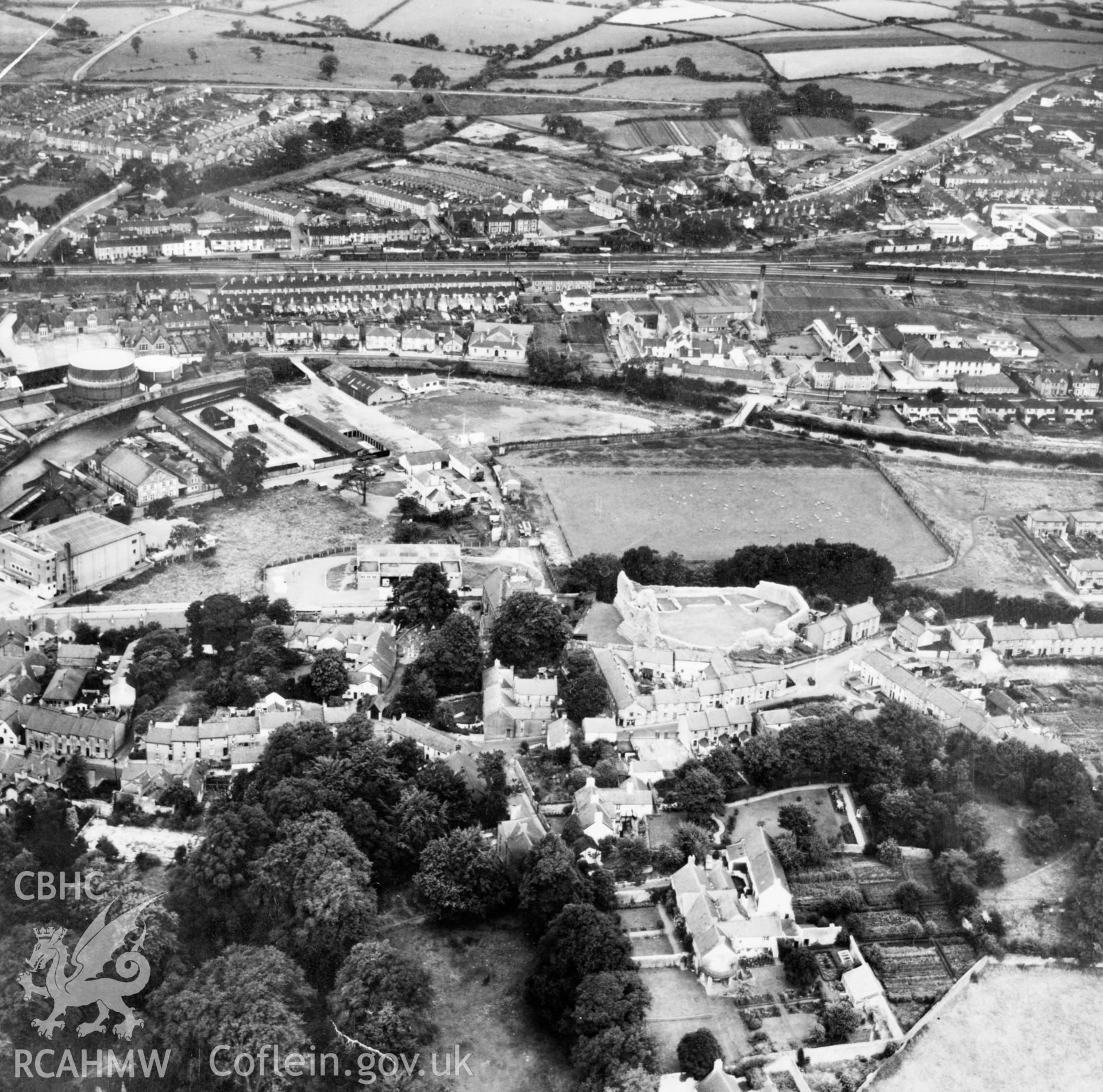 View of Bridgend showing castle, cinema, brewery field athletics ground and cattle market (reversed). Oblique aerial photograph, 5?" cut roll film.