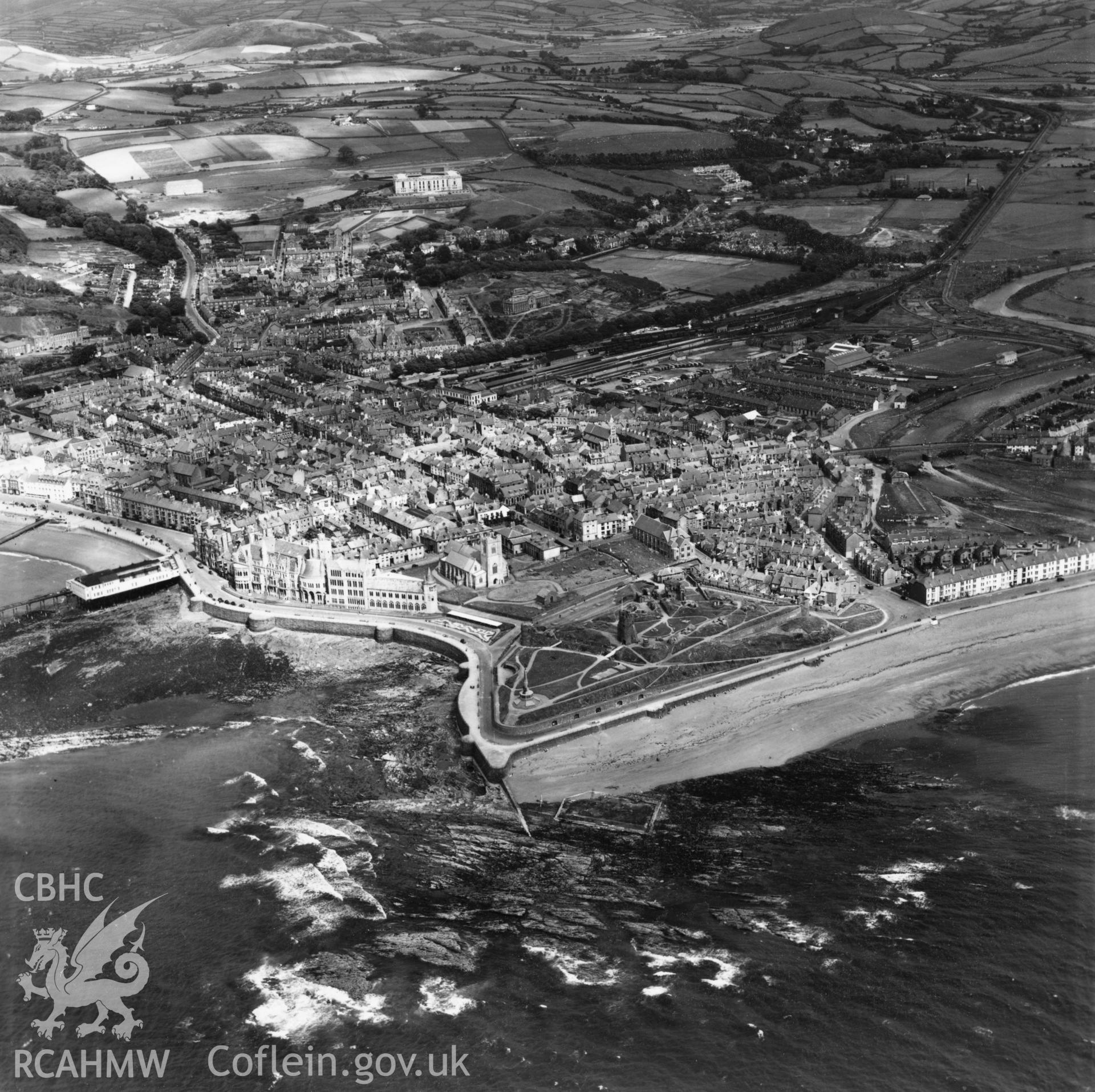 General view of Aberystwyth from the seafront looking north east, showing castle, pier and National Library of Wales. Oblique aerial photograph, 5?" cut roll film.