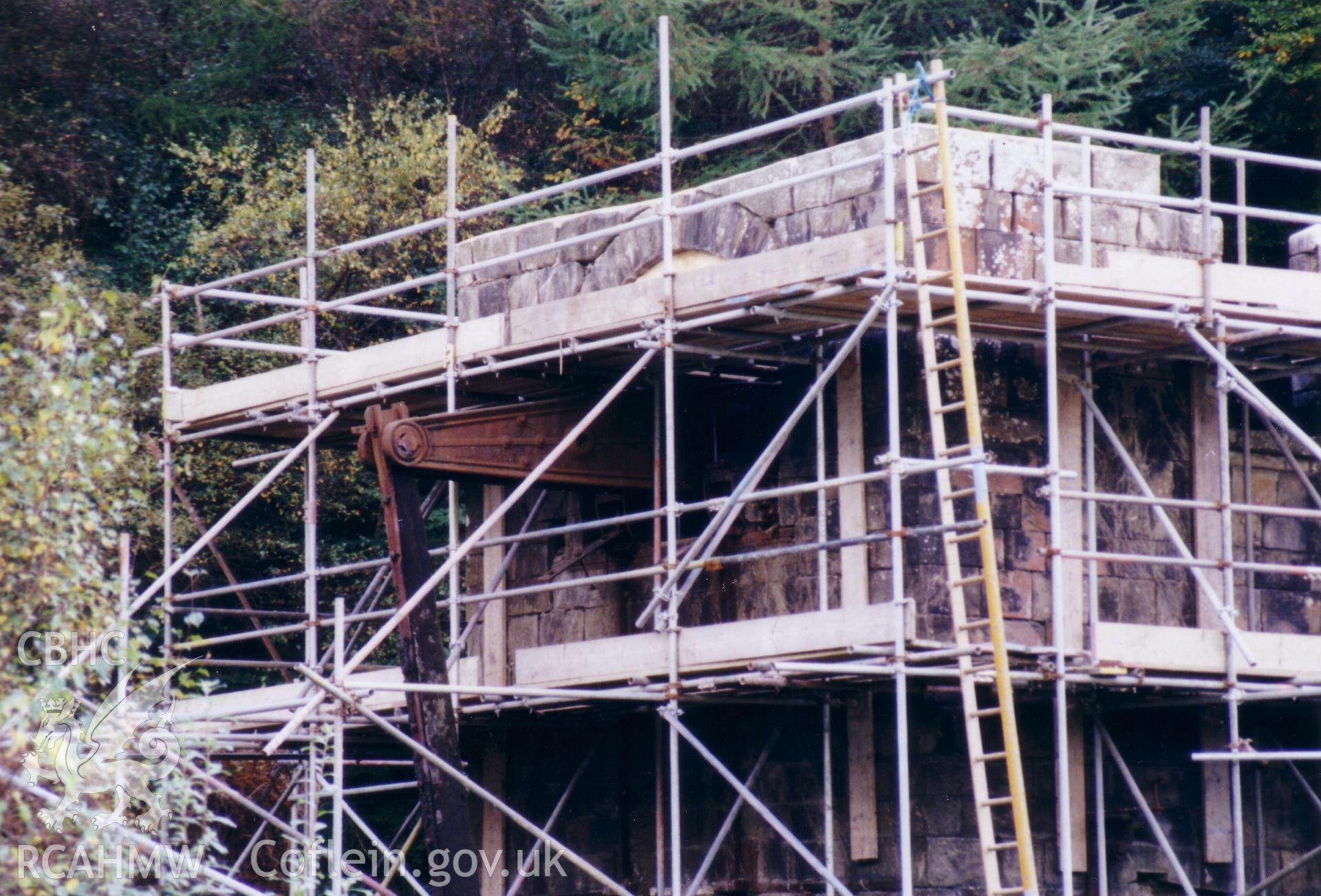Close up of vertical engine house with scaffolding.