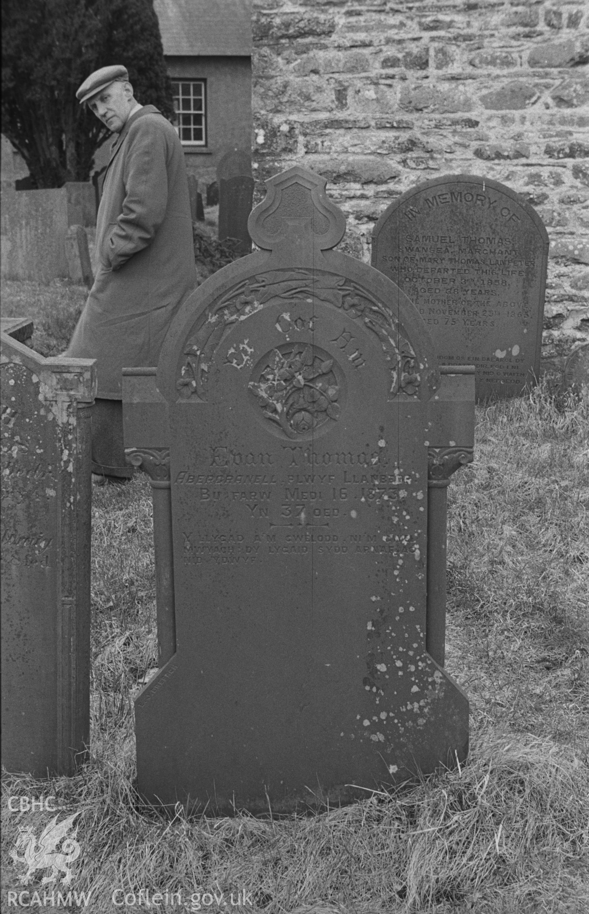 Digital copy of a black and white negative showing two tombstone in St Gwynin's churchyard to the south of the church, both with Calystegia motif for decoration. Photographed in April 1963 by Arthur O. Chater from Grid Reference SN 5332 4725.