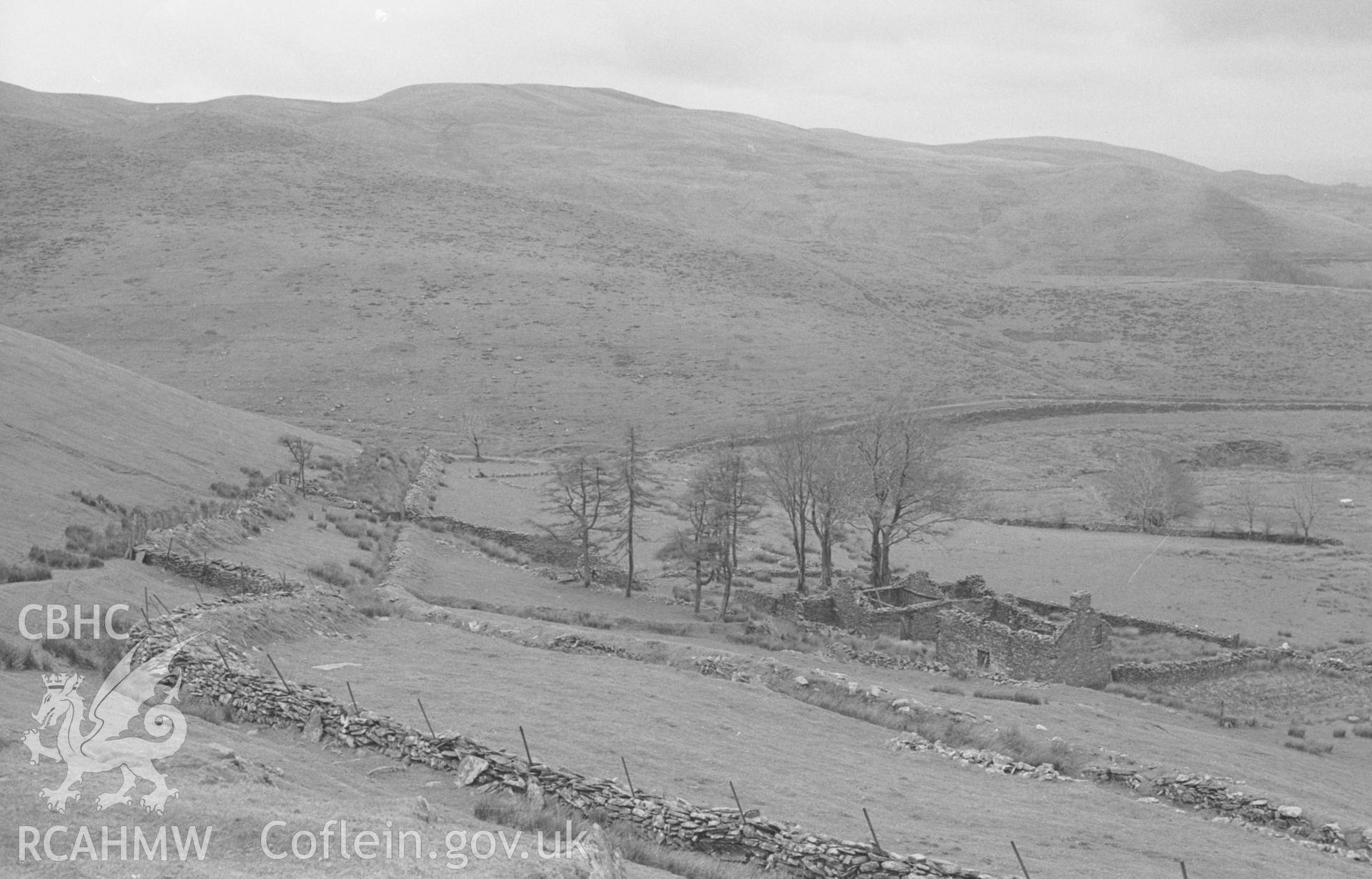 Digital copy of black & white negative showing view across ruins of Tan-y-Graig to Groes Fechan valley; trackway leading up to Carn Gron on the left. Photographed by Arthur O. Chater in April 1966 from Grid Ref SN 730 606, looking south south west.