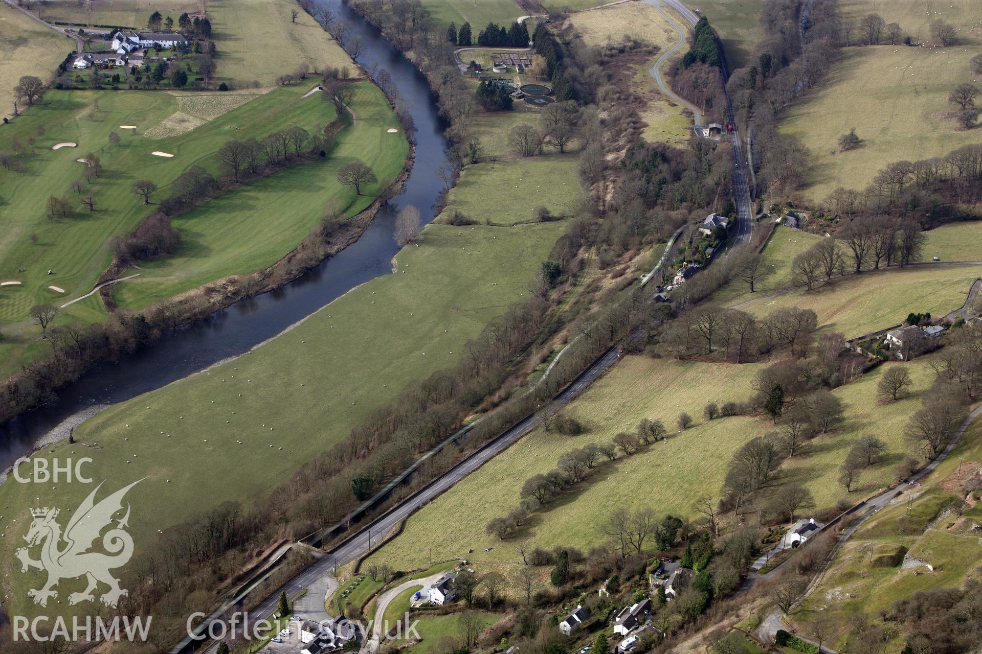 Llangollen and district golf club on the right of the photograph, with the river Dyfrdwy in the centre, and the Llangollen canal and its footpath running alongside the A5. Oblique aerial photograph taken during the Royal Commission?s programme of archaeological aerial reconnaissance by Toby Driver on 28th February 2013.
