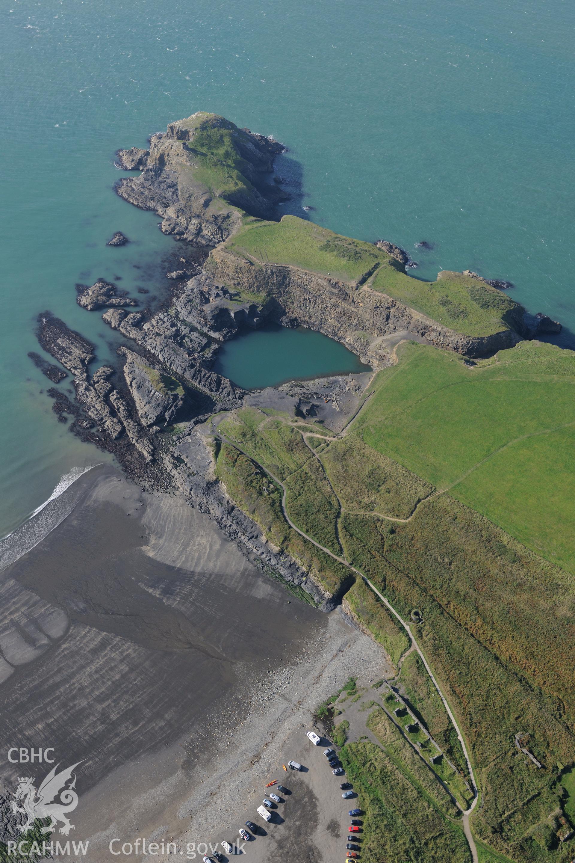 Abereiddi Tower and the remains of Porthgain slate quarry including the quarrymen's cottages; engine house and lift; workshop and what was the main quarry pit, but is now the blue lagoon. Oblique aerial photograph taken during Royal Commission's programme of archaeological aerial reconnaissance by Toby Driver on 30th September 2015.