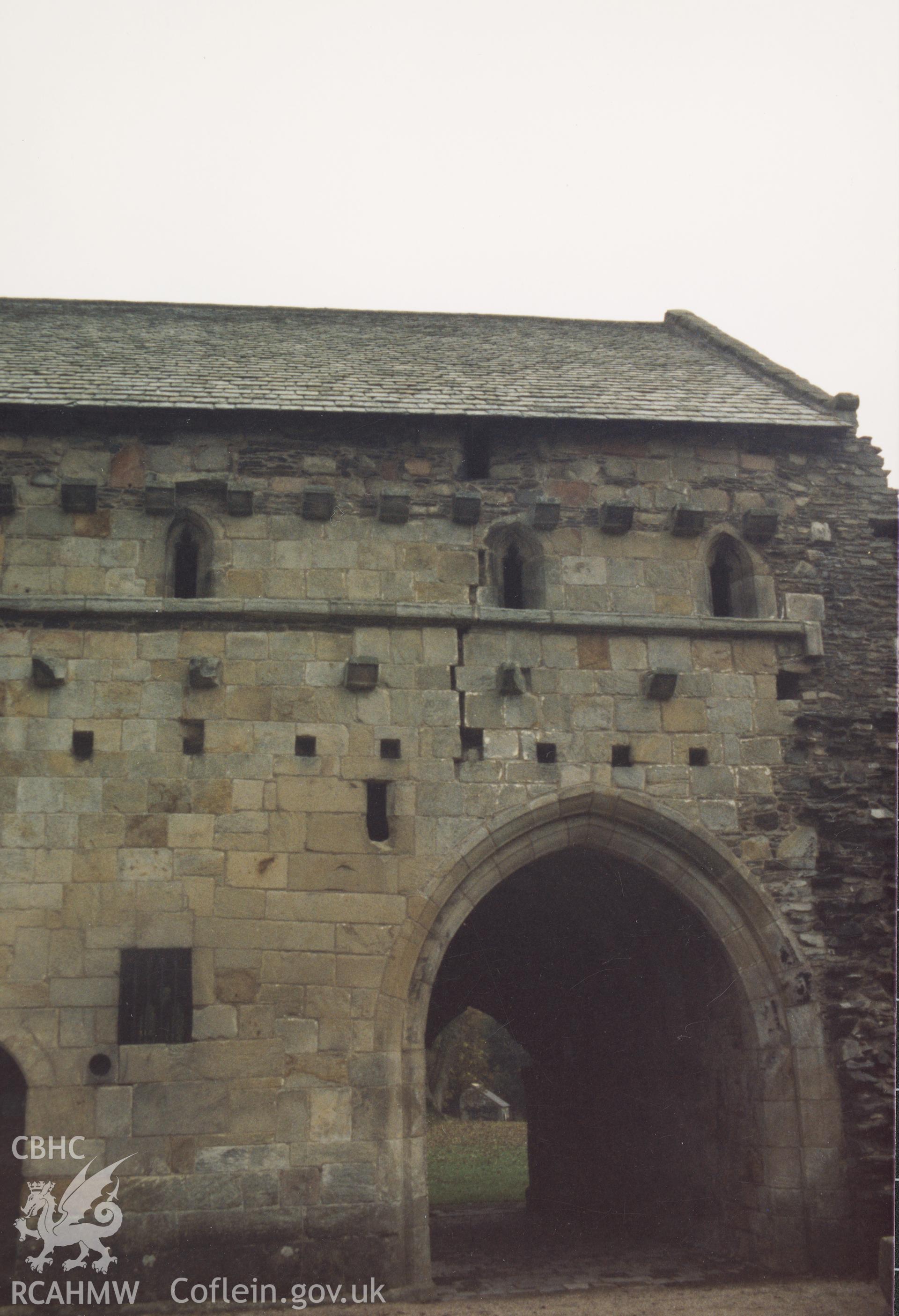 Digitised copy of a colour photograph showing crack in exterior wall to dormitory at Valle Crucis Abbey, taken by Cadw c.1989.