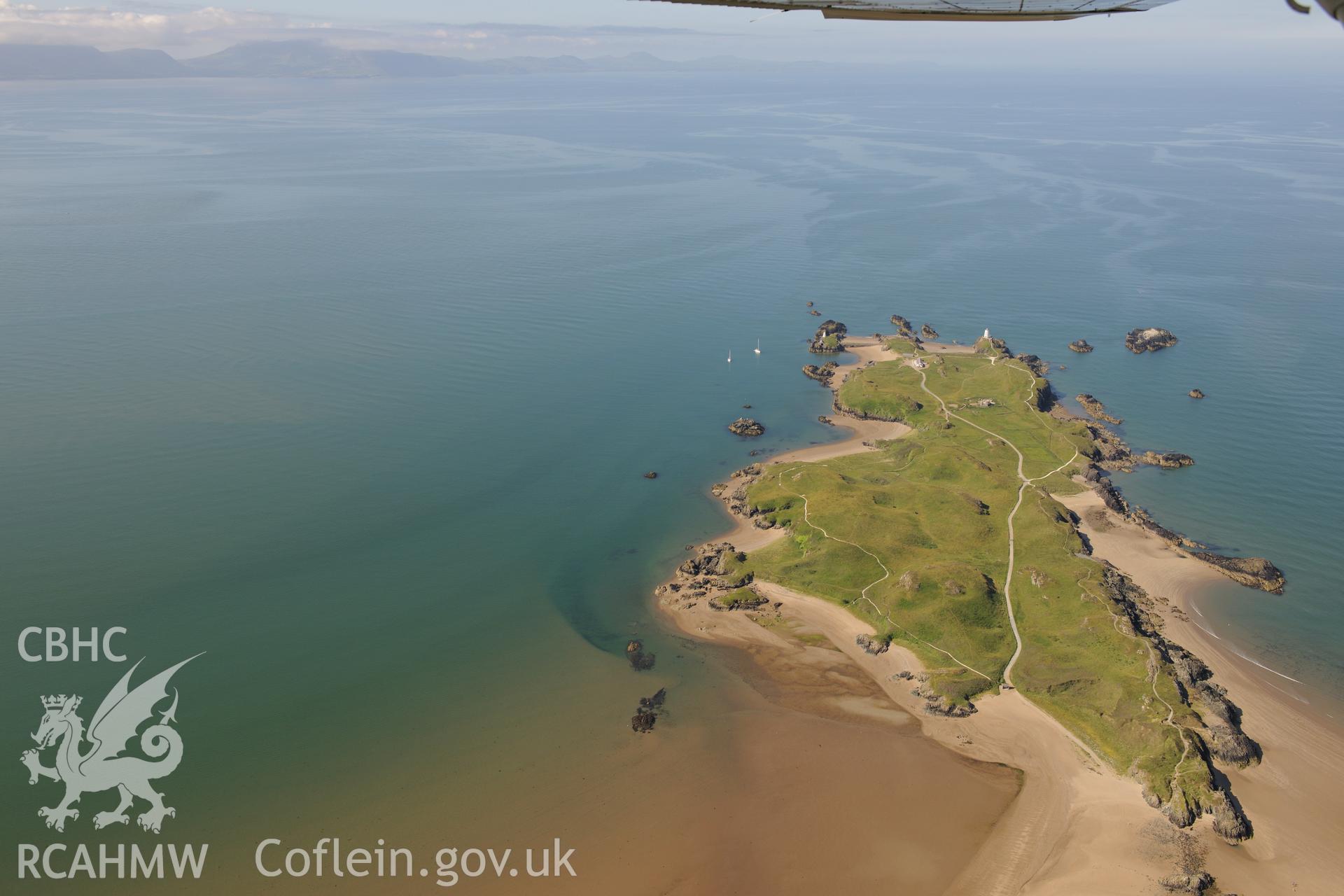 The lighthouse, pilot's house and St. Dwynwen's Church on Llanddwyn Island. Oblique aerial photograph taken during the Royal Commission's programme of archaeological aerial reconnaissance by Toby Driver on 23rd June 2015.