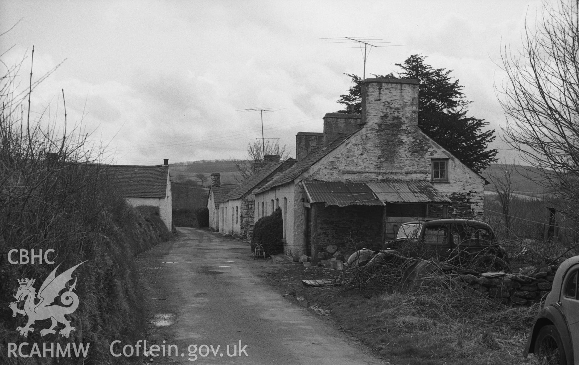 Digital copy of a black and white negative showing old cottages of Dre-Fach, Llanwnnen, 300m south east of the church. Photographed in April 1963 by Arthur O. Chater from Grid Reference SN 5357 4708, looking south east.