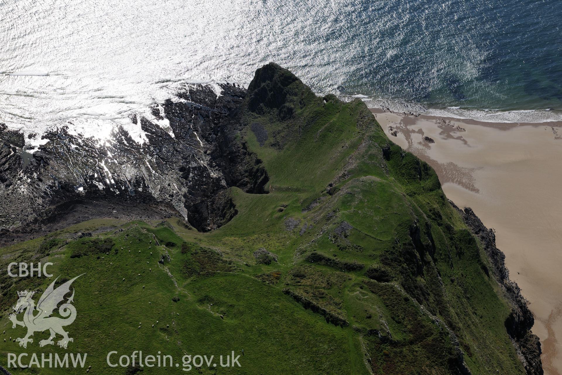 Thurba Camp defended enclosure, south of Rhossili, on the south western coast of the Gower Peninsula. Oblique aerial photograph taken during the Royal Commission's programme of archaeological aerial reconnaissance by Toby Driver on 30th September 2015.
