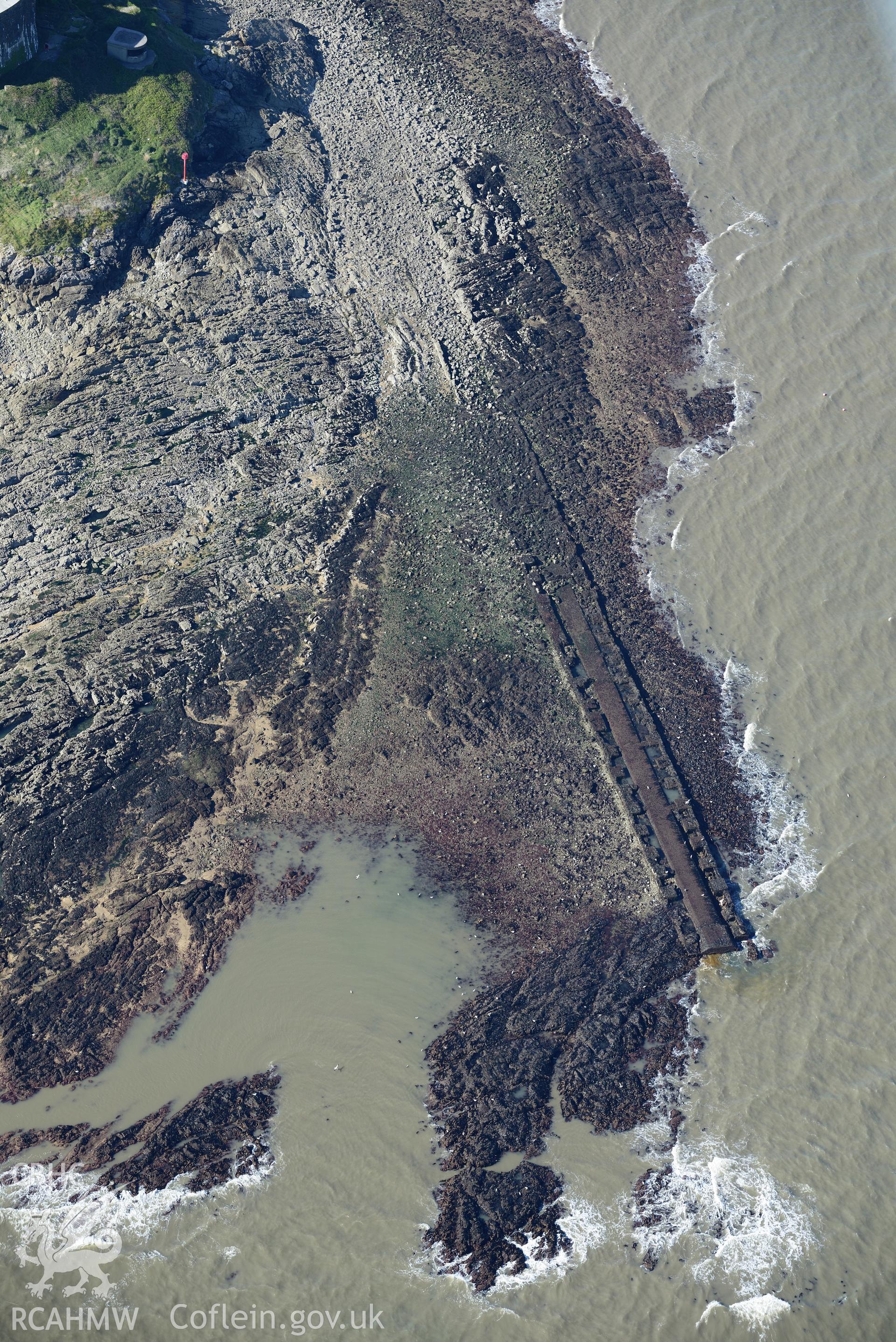 The rocks around Mumbles lighthouse, on south western edge of Swansea Bay. Oblique aerial photograph taken during the Royal Commission's programme of archaeological aerial reconnaissance by Toby Driver, 30th September 2015.