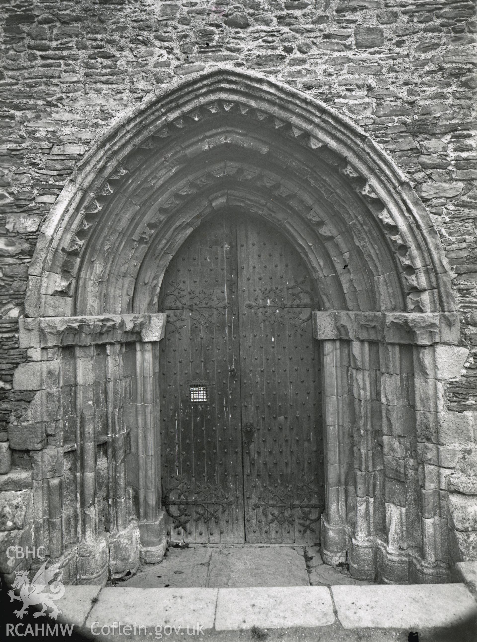 Digitised copy of a black and white photograph showing west door of church at Valle Crucis Abbey, taken by F.H. Crossley, 1949. Copied from print as negative held by NMR England (Historic England)