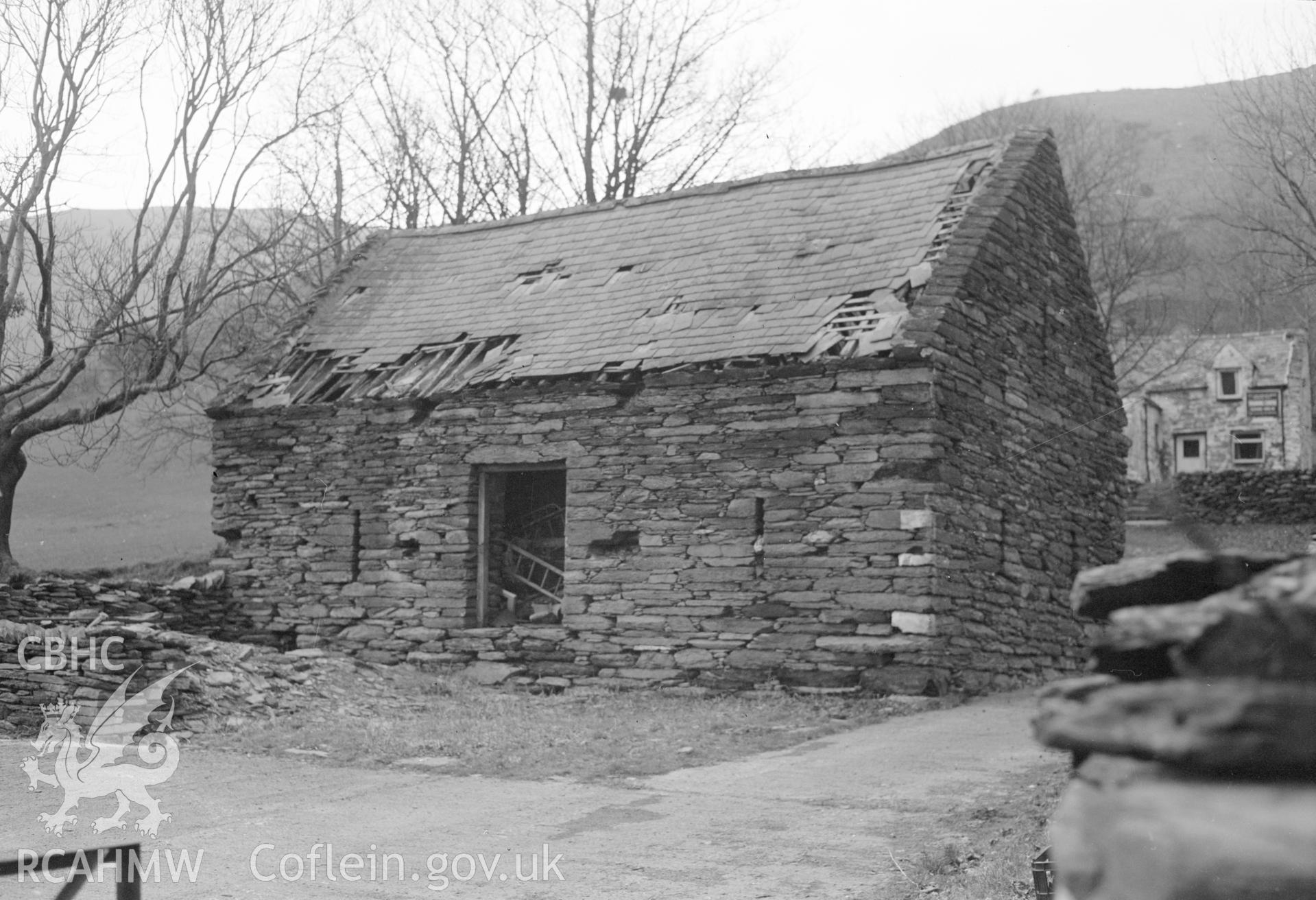 Digital copy of an black and white photograph showing an exterior view of Pen y Garreg Barn.