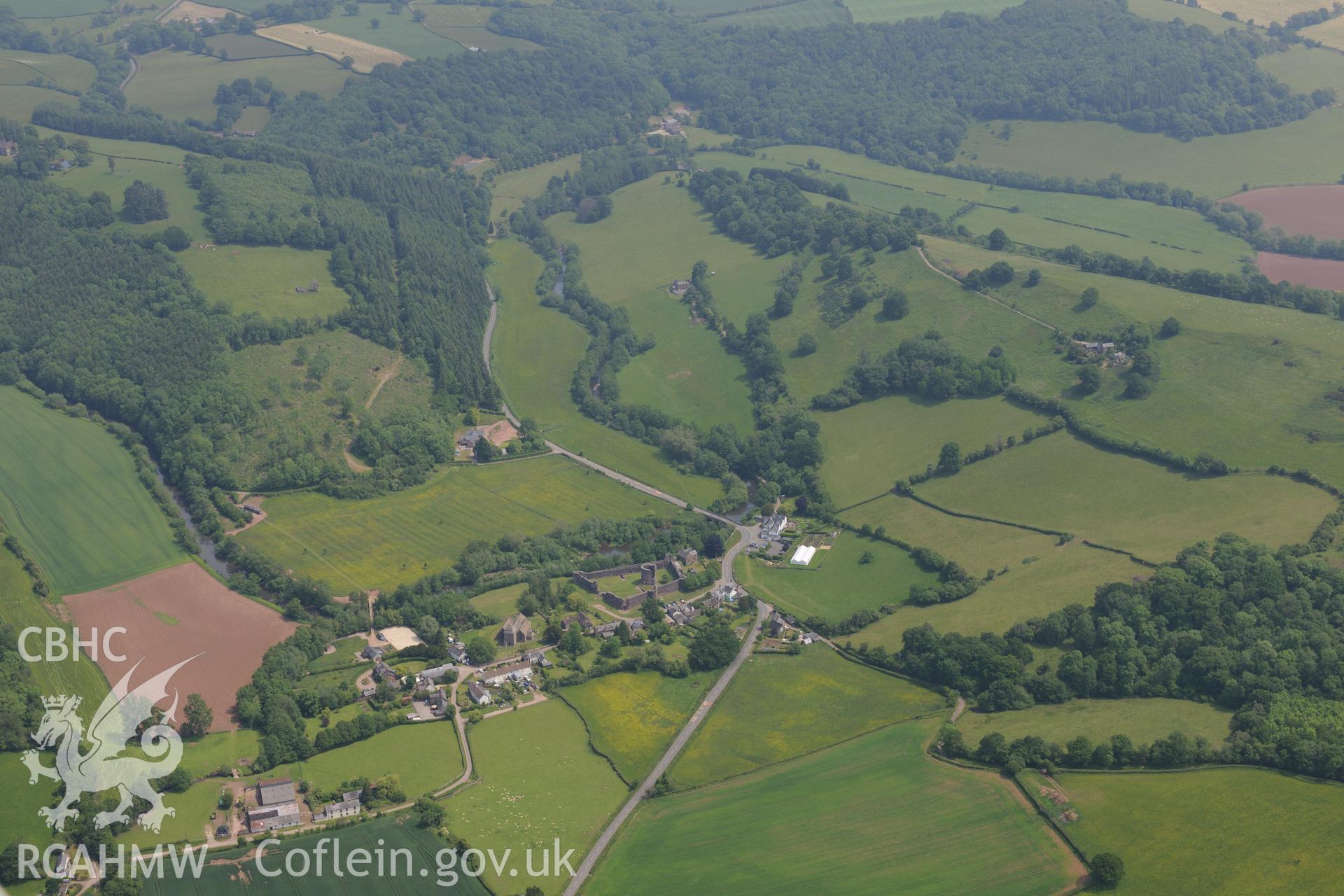Skenfrith town including views of the castle and St. Bridget's Church. Oblique aerial photograph taken during the Royal Commission's programme of archaeological aerial reconnaissance by Toby Driver on 11th July 2015.