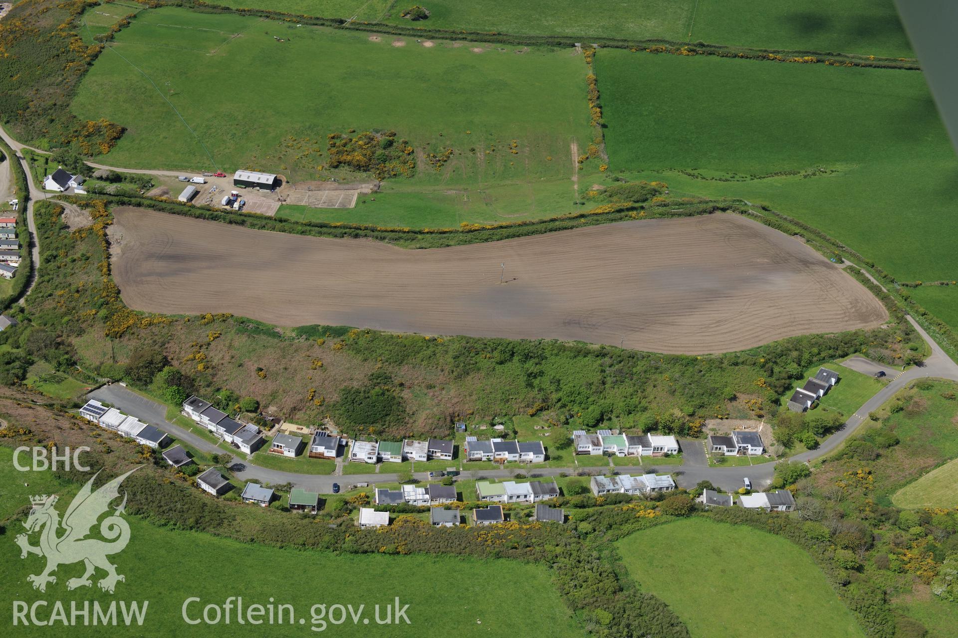 The village of Nolton Haven with soilmarks in field at Nolton Haven farm above.  Oblique aerial photograph taken during the Royal Commission's programme of archaeological aerial reconnaissance by Toby Driver on 13th May 2015.
