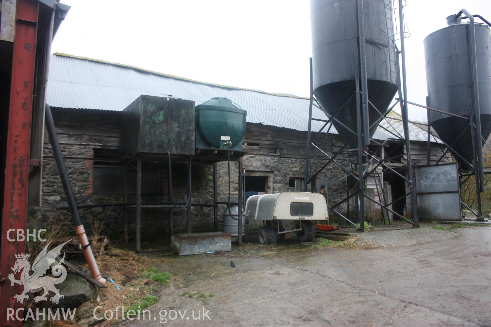Exterior view of shed or barn with agricultural silos and oil tanks. Photographic survey of Glanhafon-Fawr Farmstead conducted by Geoff Ward on 4th November 2010.