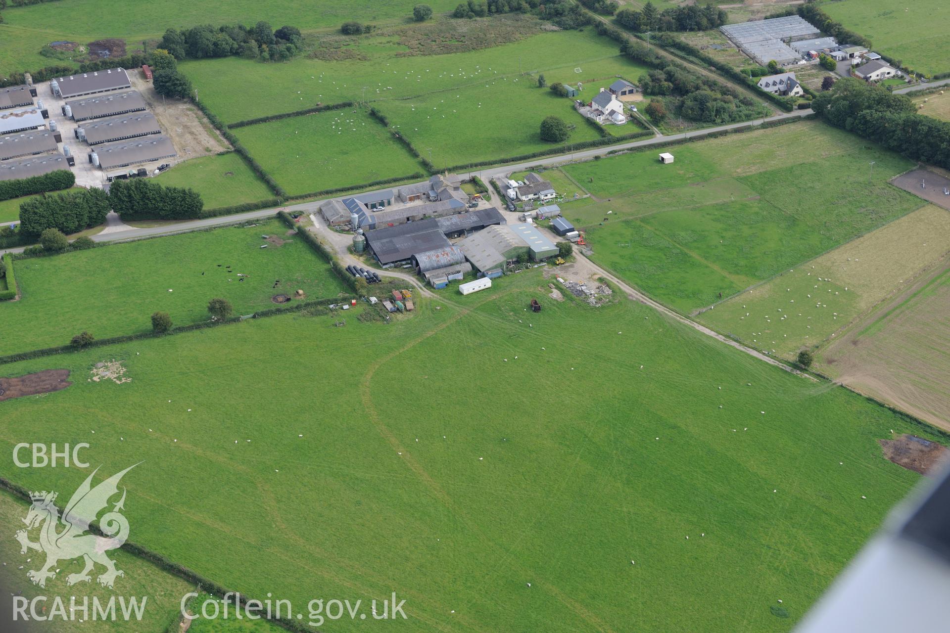 Circle, barrow and linear earthworks at Holywell, and a circle and tumulus at Holywell Racecourse. Oblique aerial photograph taken during the Royal Commission's programme of archaeological aerial reconnaissance by Toby Driver on 11th September 2015