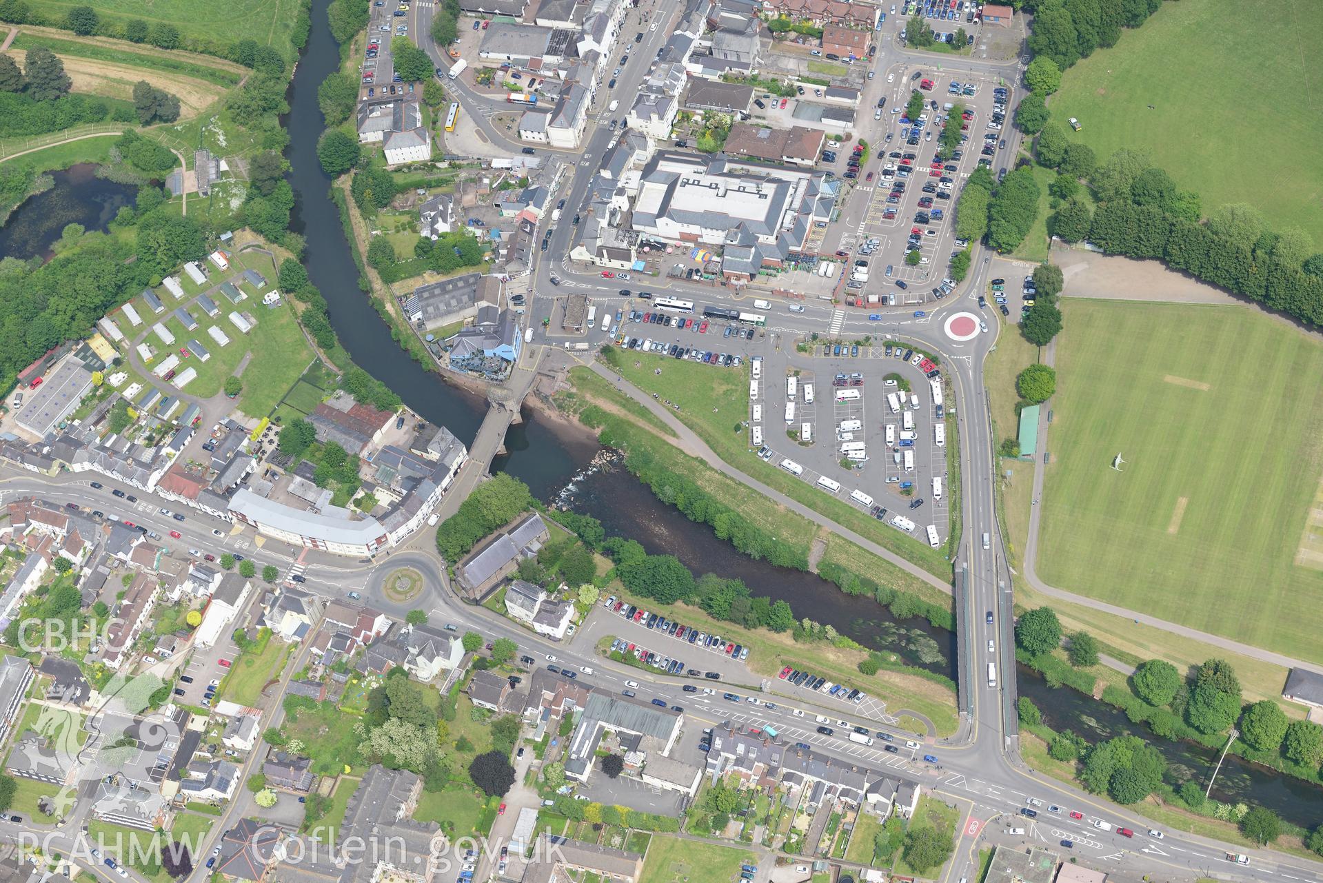 St. Thomas' Church and Monnow bridge and gate, Monmouth. Oblique aerial photograph taken during the Royal Commission's programme of archaeological aerial reconnaissance by Toby Driver on 11th June 2015.