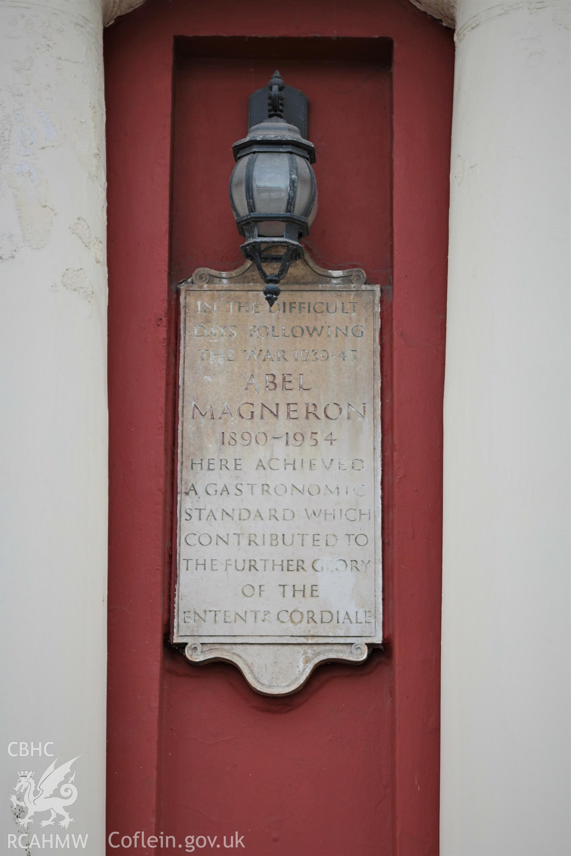 Colour photograph of plaque at the Big Windsor, Stuart Street, Butetown. Transcript: ABEL MAGNERON 1890-1954 HERE ACHIEVED A GASTRONOMIC STANDARD WHICH CONTRIBUTED TO THE FURTHER GLORY OF THE ENTENT CORDIALE. Photographed by Rita Singer on 17/7/2018.