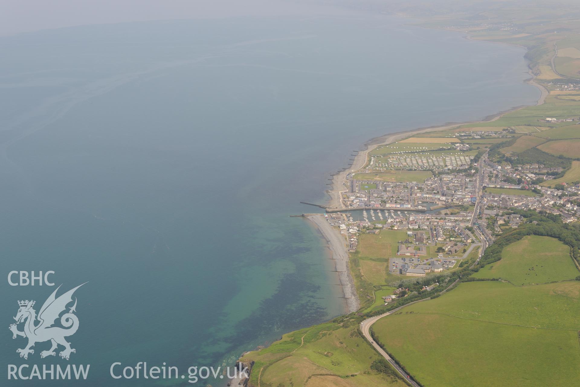 View of Aberaeron from the south west, showing the Penmorfa Council Buildings and Aberaeron Harbour. Oblique aerial photograph taken during the Royal Commission?s programme of archaeological aerial reconnaissance by Toby Driver on 12th July 2013.