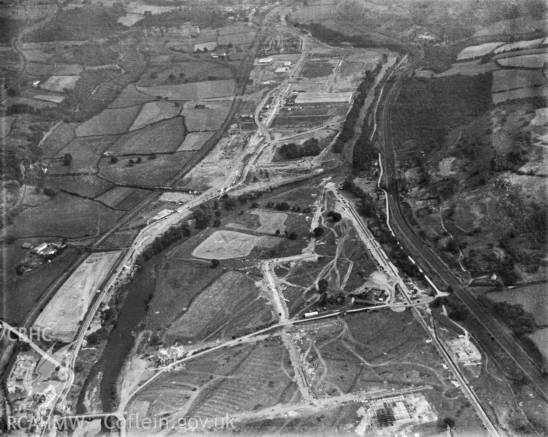 Black and white oblique aerial photograph showing Treforest Trading Estate, from Aerofilms album Glamorgan S-Z (W29). View of the estate looking south-east in 1937. At this point in the Taff Valley were, from east to west, the Alexandra Railway, the disused Glamorganshire Canal, Nantgarw Colliery, the dismantled Cardiff Railway, the A470 North-South Trunk Road, seen in this section as a dual carriageway, the buildings of the trading estate, River Taff and the four-tracked Taff Vale Railway.