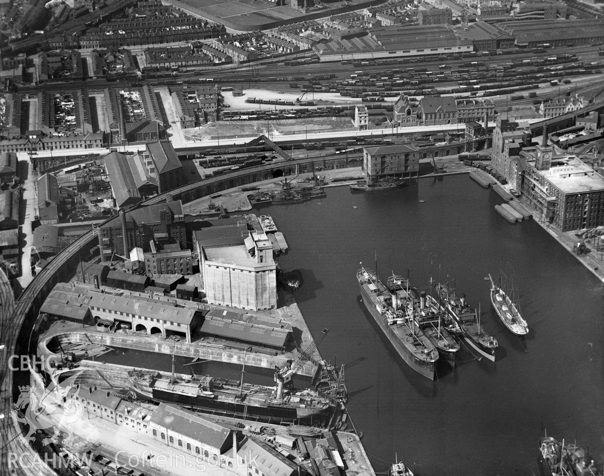 Black and white oblique aerial photograph showing Cardiff Docks, from Aerofilms album Cardiff (W22), taken by Aerofilms Ltd and dated 1921.