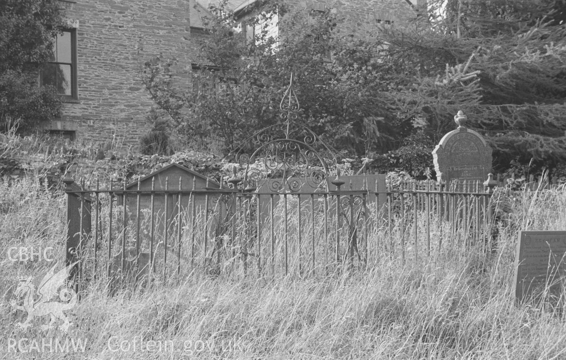 Digital copy of a black and white negative showing wrought and cast iron grave enclosure in the churchyard at Llandysul. Photographed by Arthur O. Chater in August 1965 from Grid Reference SN 4188 4070, looking north west.