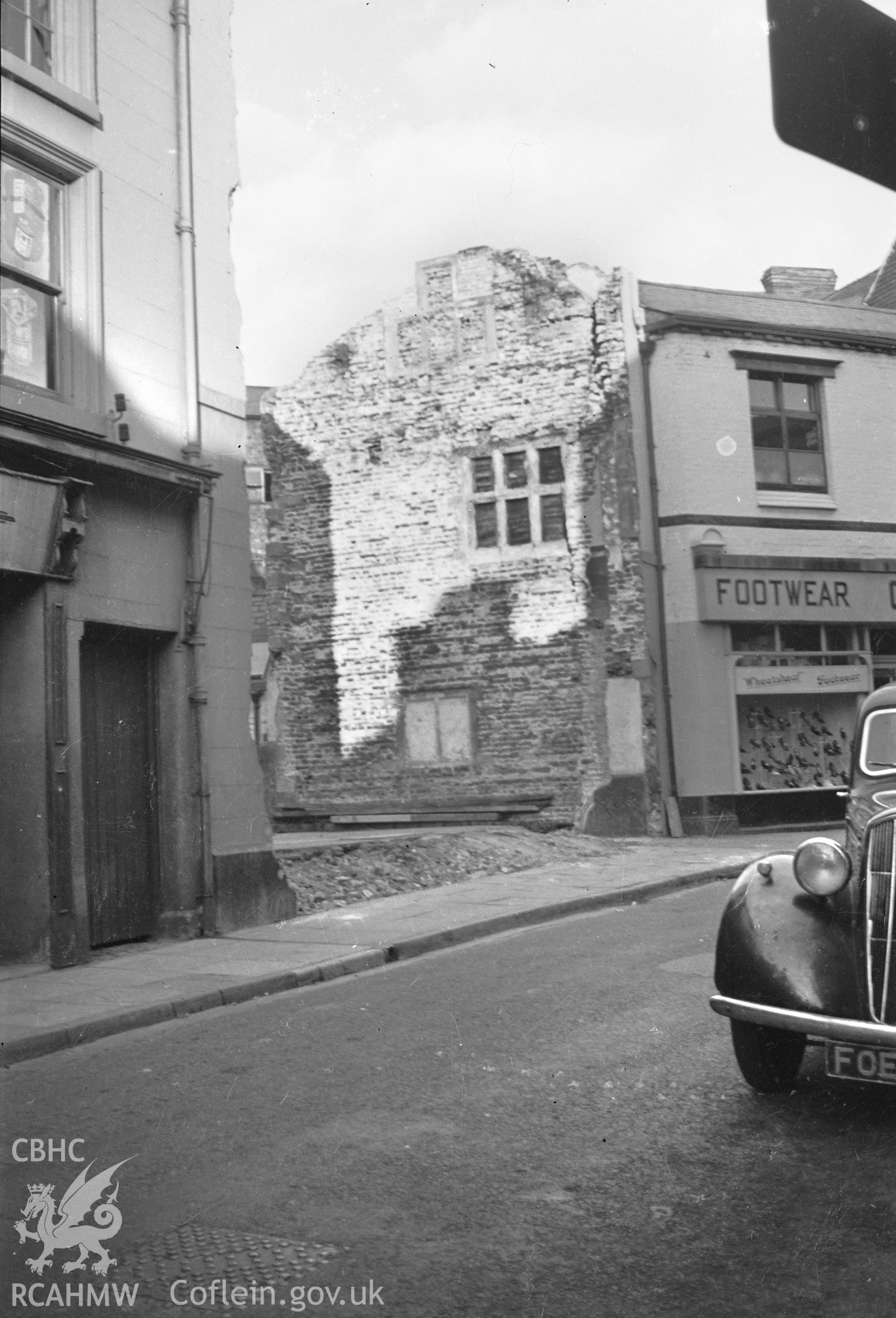 Digital copy of a nitrate negative showing street view in Wrexham wiht demolished building, taken by RCAHMW.