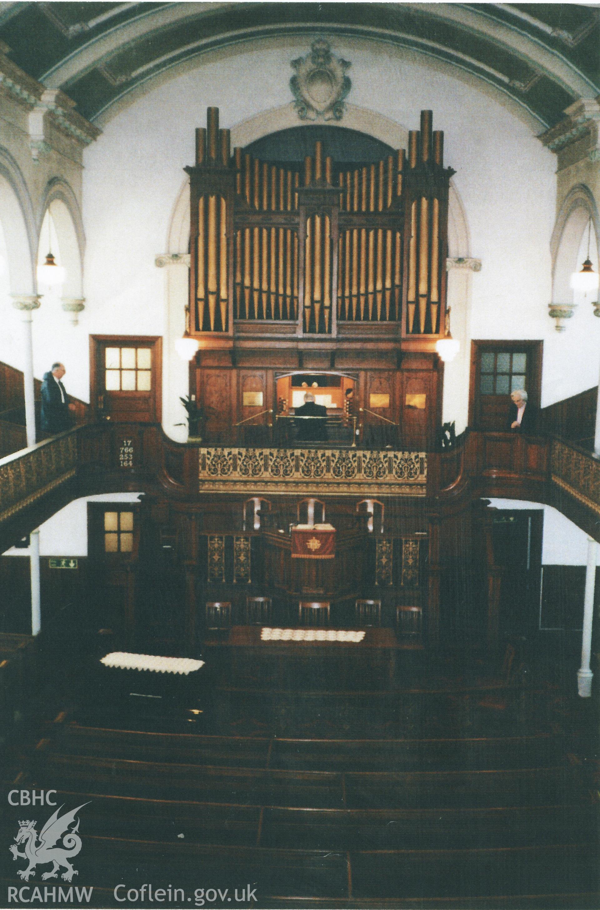 Colour photograph of past organist Aneurin Thomas, playing the organ for the last time, 2003. Donated to the RCAHMW by Cyril Philips as part of the Digital Dissent Project.