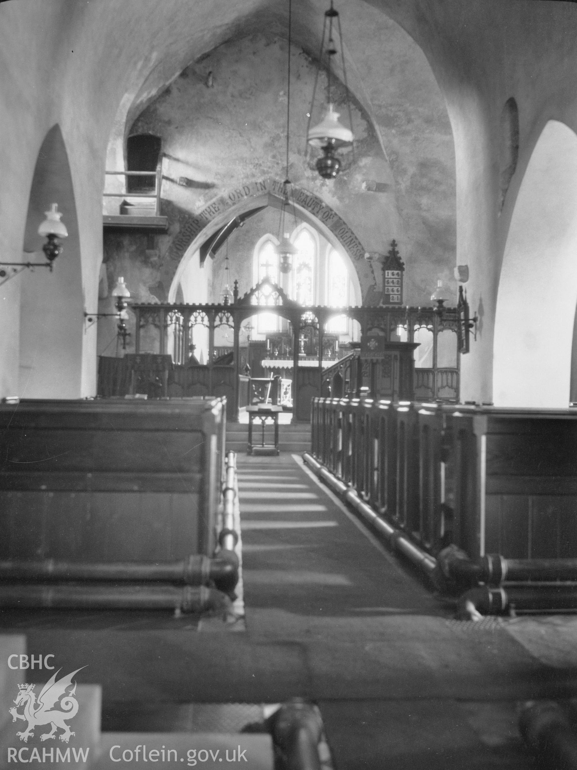 Digital copy of a nitrate negative showing interior view from west, looking towards the altar, St James's Church, Manorbier. From the National Building Record Postcard Collection.