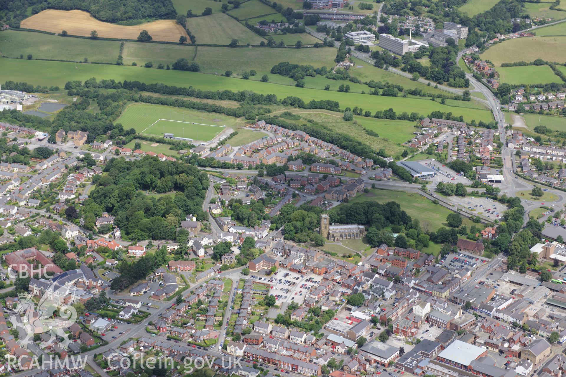 Mold Castle, Bailey Hill Garden and St. Mary's Church. Oblique aerial photograph taken during the Royal Commission's programme of archaeological aerial reconnaissance by Toby Driver on 30th July 2015.