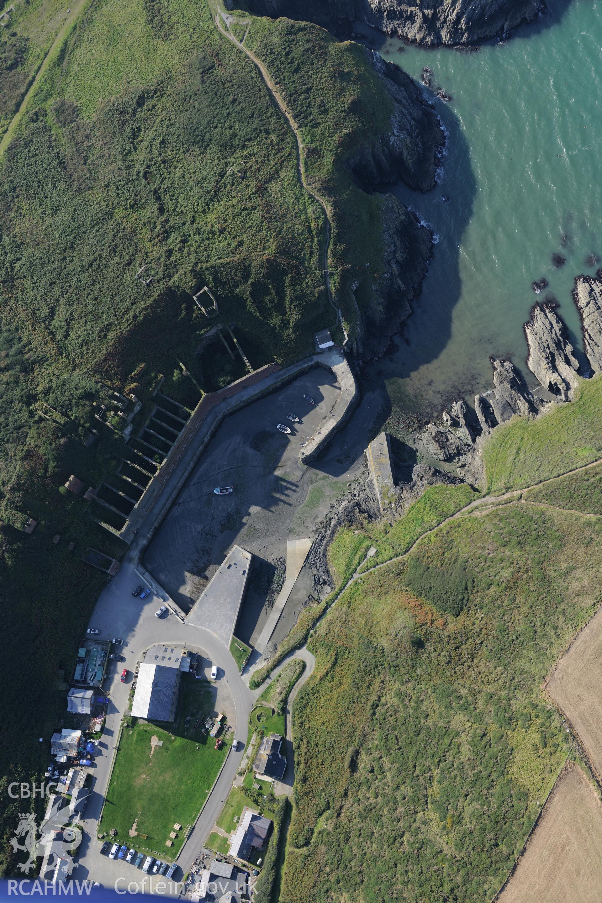 Remains of Porthgain quarry including the harbour and brickworks. Oblique aerial photograph taken during the Royal Commission's programme of archaeological aerial reconnaissance by Toby Driver on 30th September 2015.