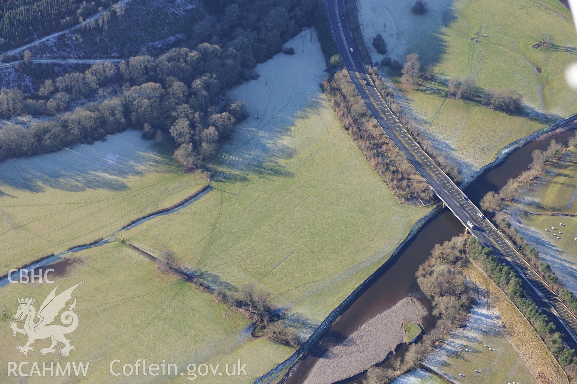 Water meadows north east of Closcoed and the bridge taking the A40 Brecon bypass over the river Usk, on the southern edge of Brecon. Oblique aerial photograph taken during the Royal Commission?s programme of archaeological aerial reconnaissance by Toby Driver on 15th June 2013.