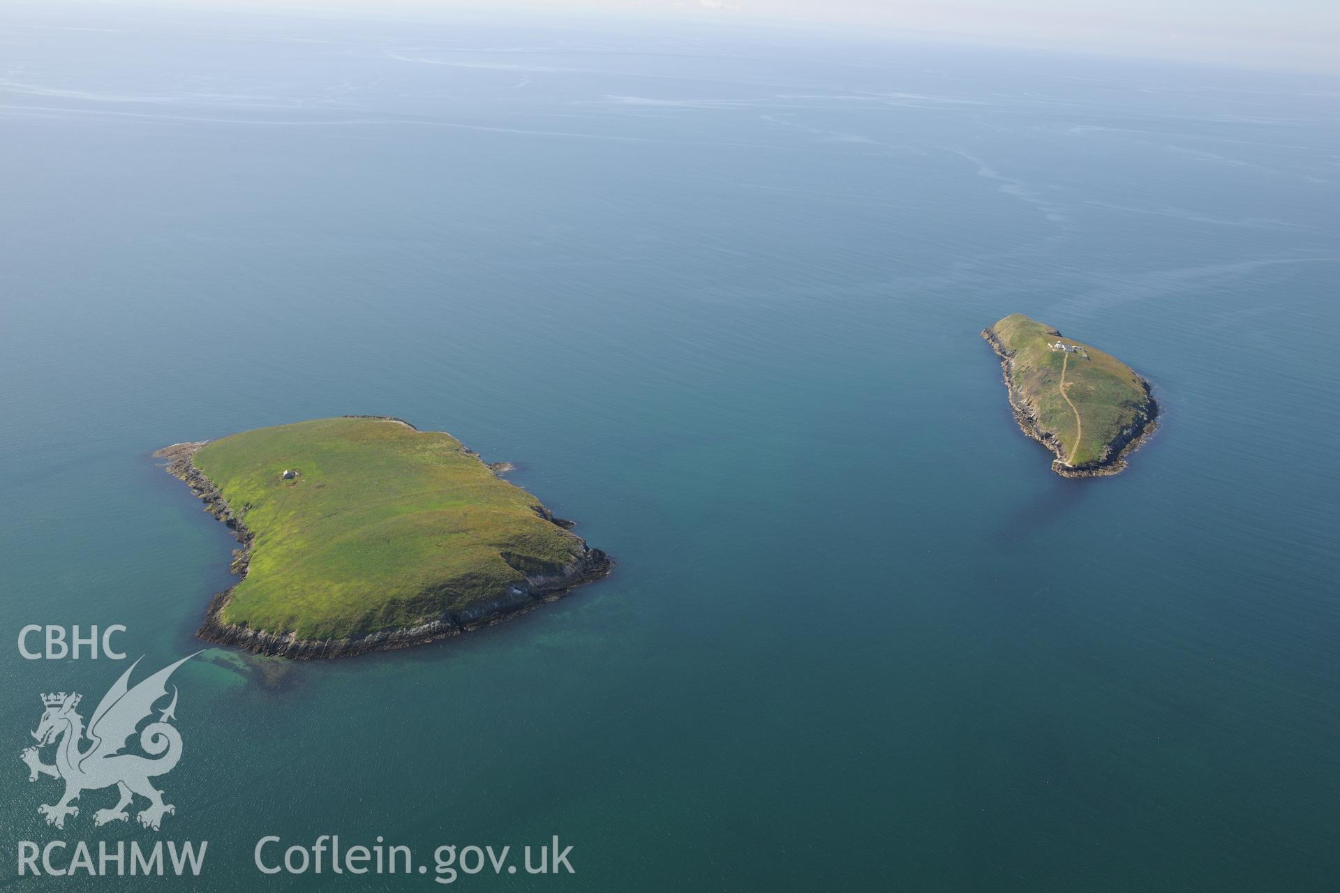 Chapel building on St. Tudwal's Island East, fishtrap off its coast, and lighthouse on St. Tudwal's Island West. Oblique aerial photograph taken during the Royal Commission's programme of archaeological aerial reconnaissance by Toby Driver on 23/06/2015.