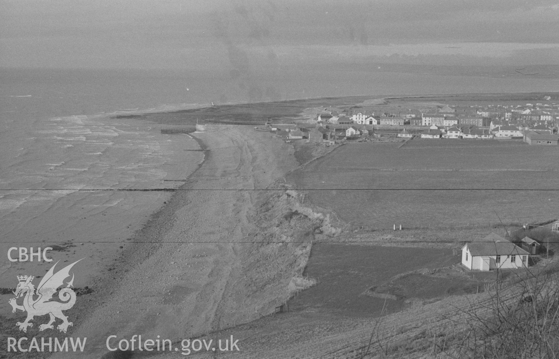 Digital copy of a black and white negative showing view of Aberaeron town and beach from bend in the main road. Photographed in April 1963 by Arthur O. Chater from Grid Reference SN 450 625, looking north east.