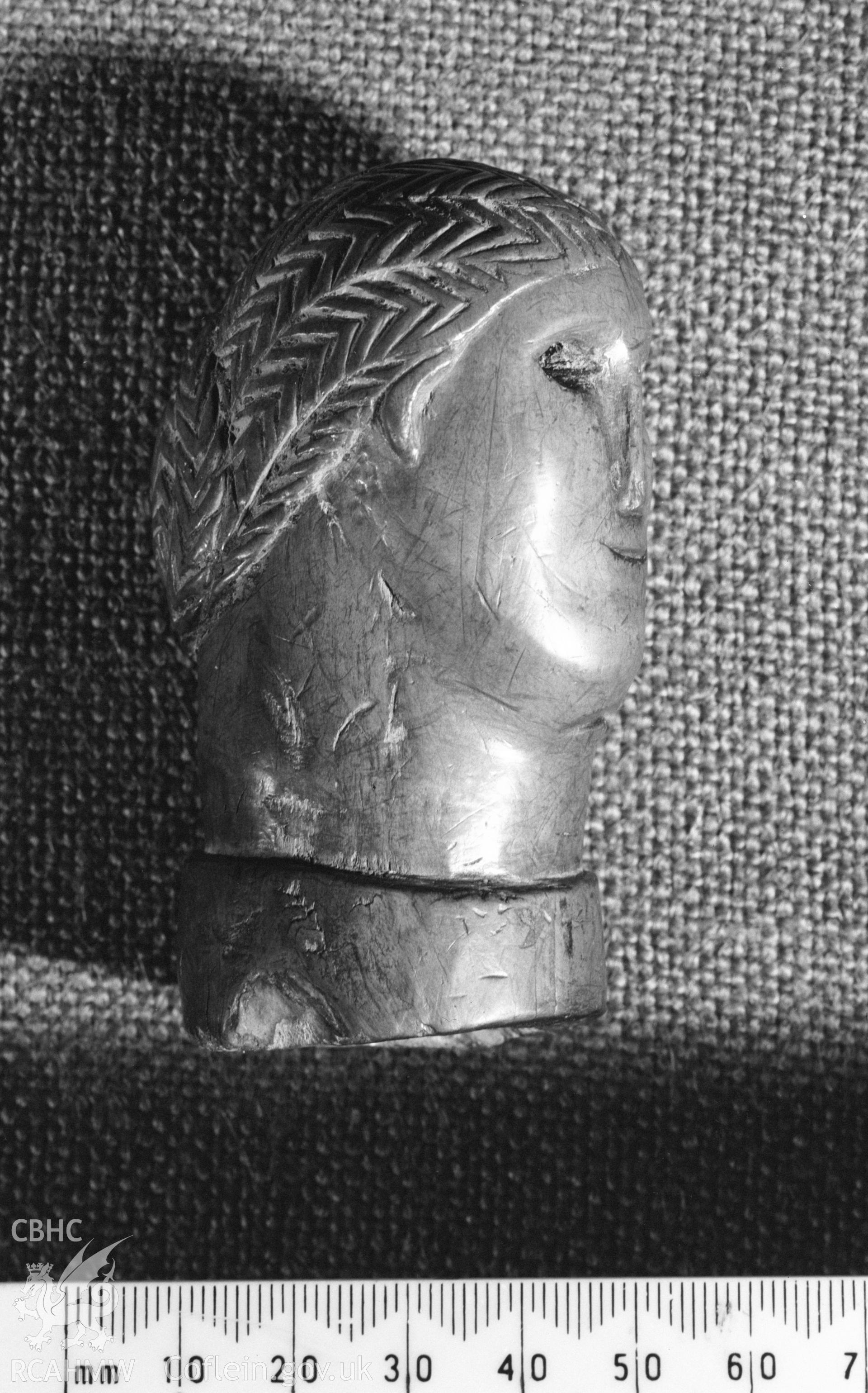 Digital copy of a black and white negative showing carved wooden head from Llanio Roman Fort.