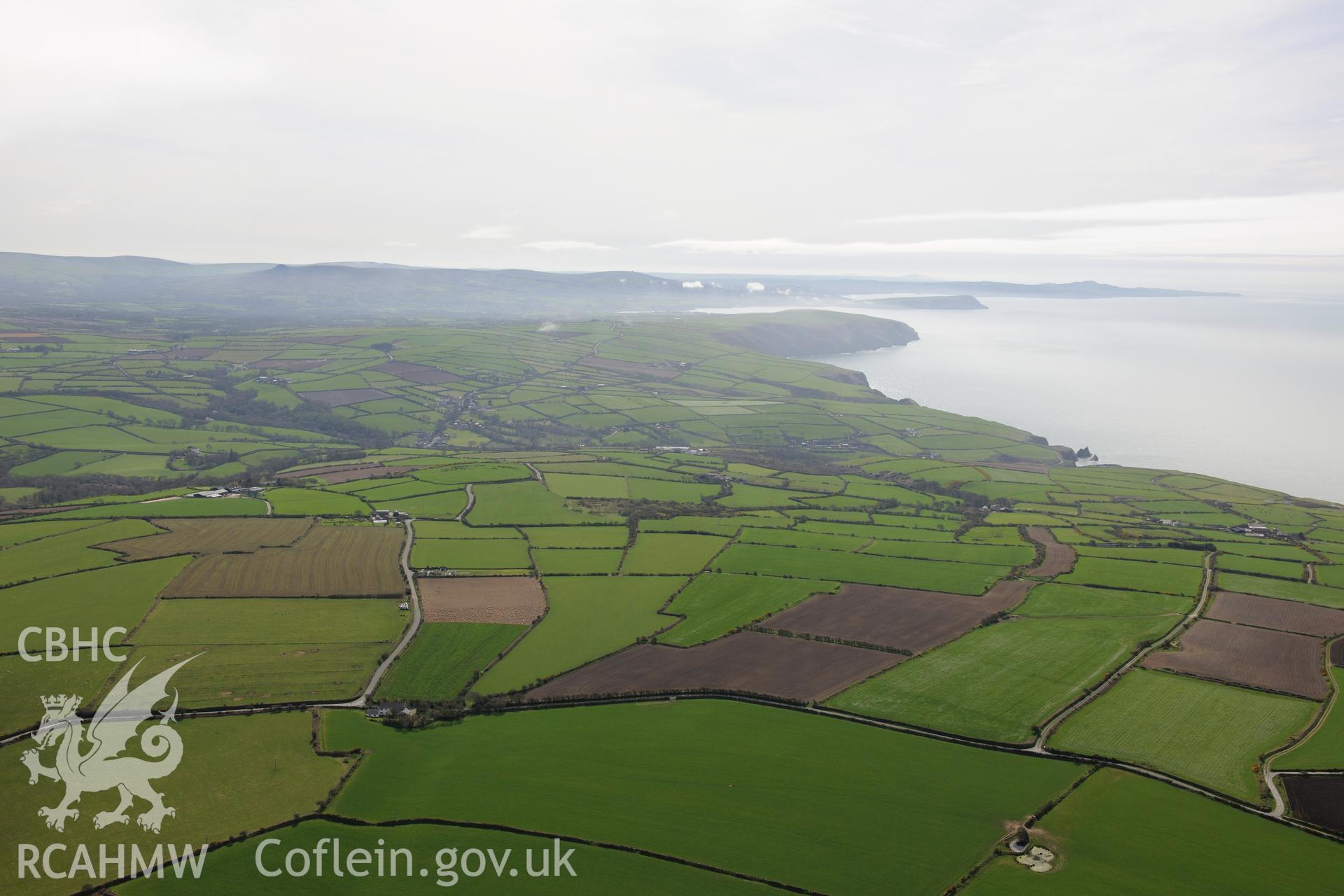 Caerau, Moylgrove and the Pembrokeshire Coast Path between Ceibwr Bay and Foel Hendre. Oblique aerial photograph taken during the Royal Commission's programme of archaeological aerial reconnaissance by Toby Driver on 15th April 2015.