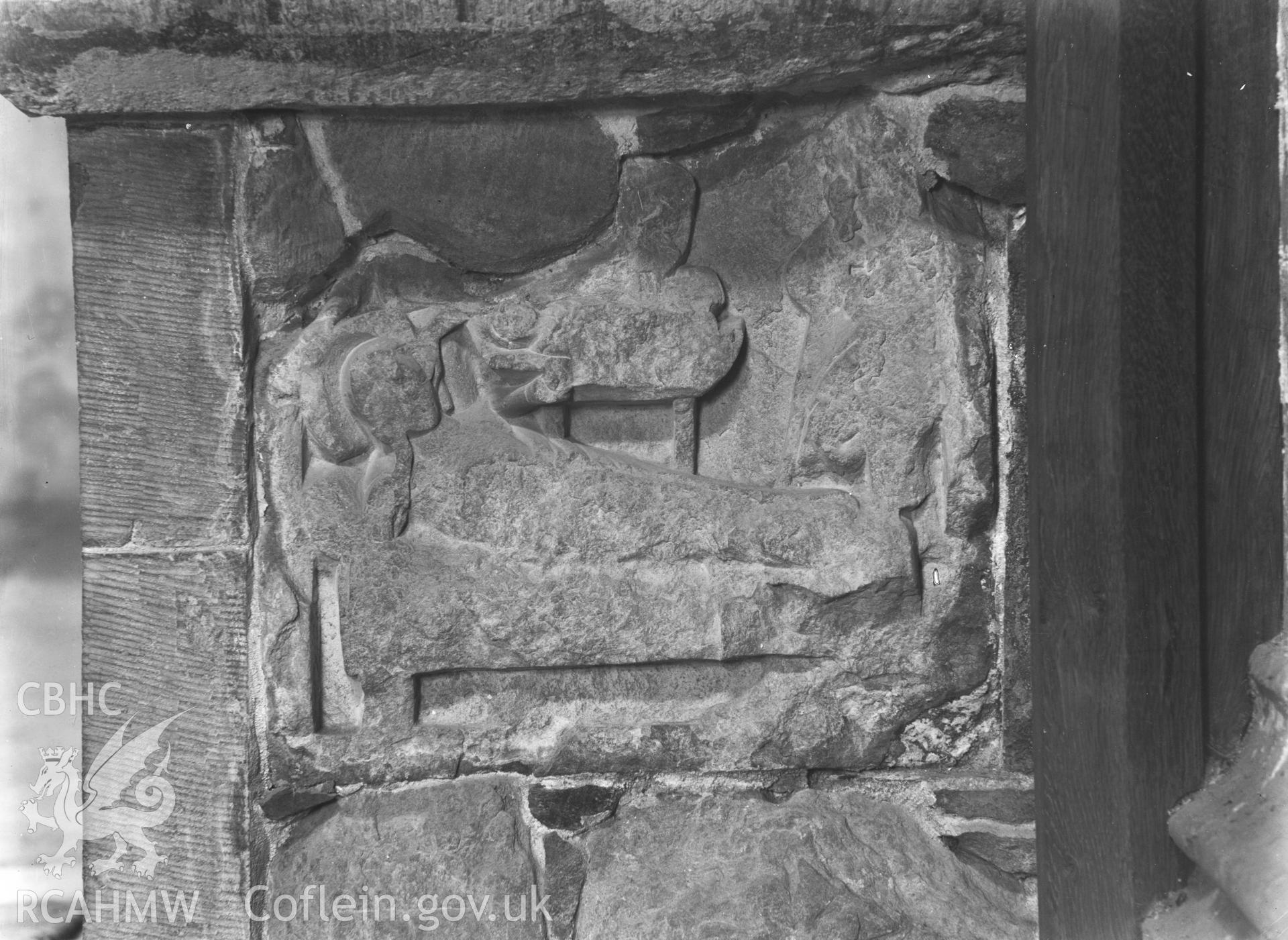 Digital copy of a black and white acetate negative showing view of sculpted stone inserted into external wall at St. David's Cathedral, taken by E.W. Lovegrove, July 1936.