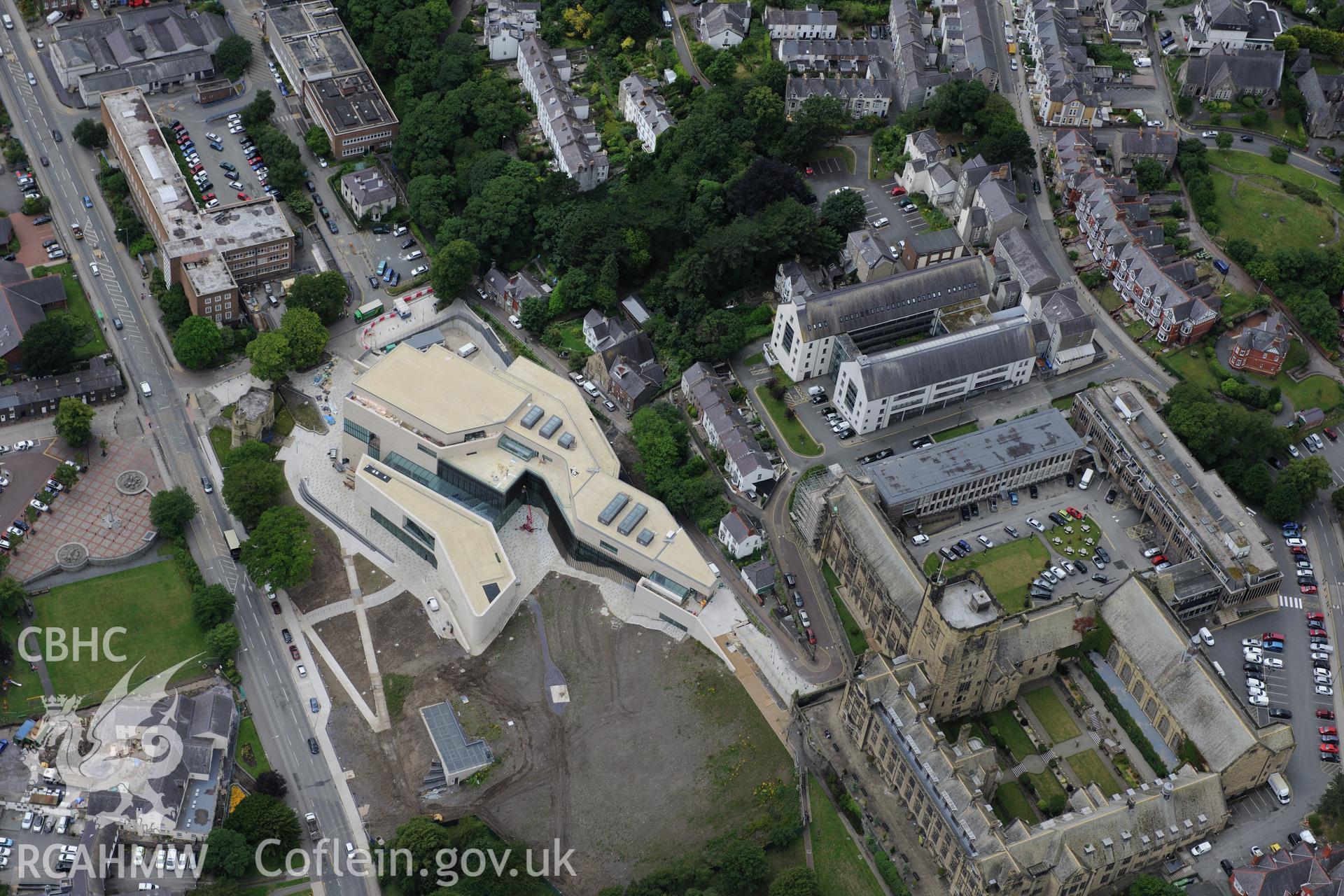 Bangor University, Theatr Gwynedd (demolished), Pontio, War Memorial, Baptist Church & Presbyterian Church. Oblique aerial photograph taken during the Royal Commission's programme of archaeological aerial reconnaissance by Toby Driver on 30th July 2015.