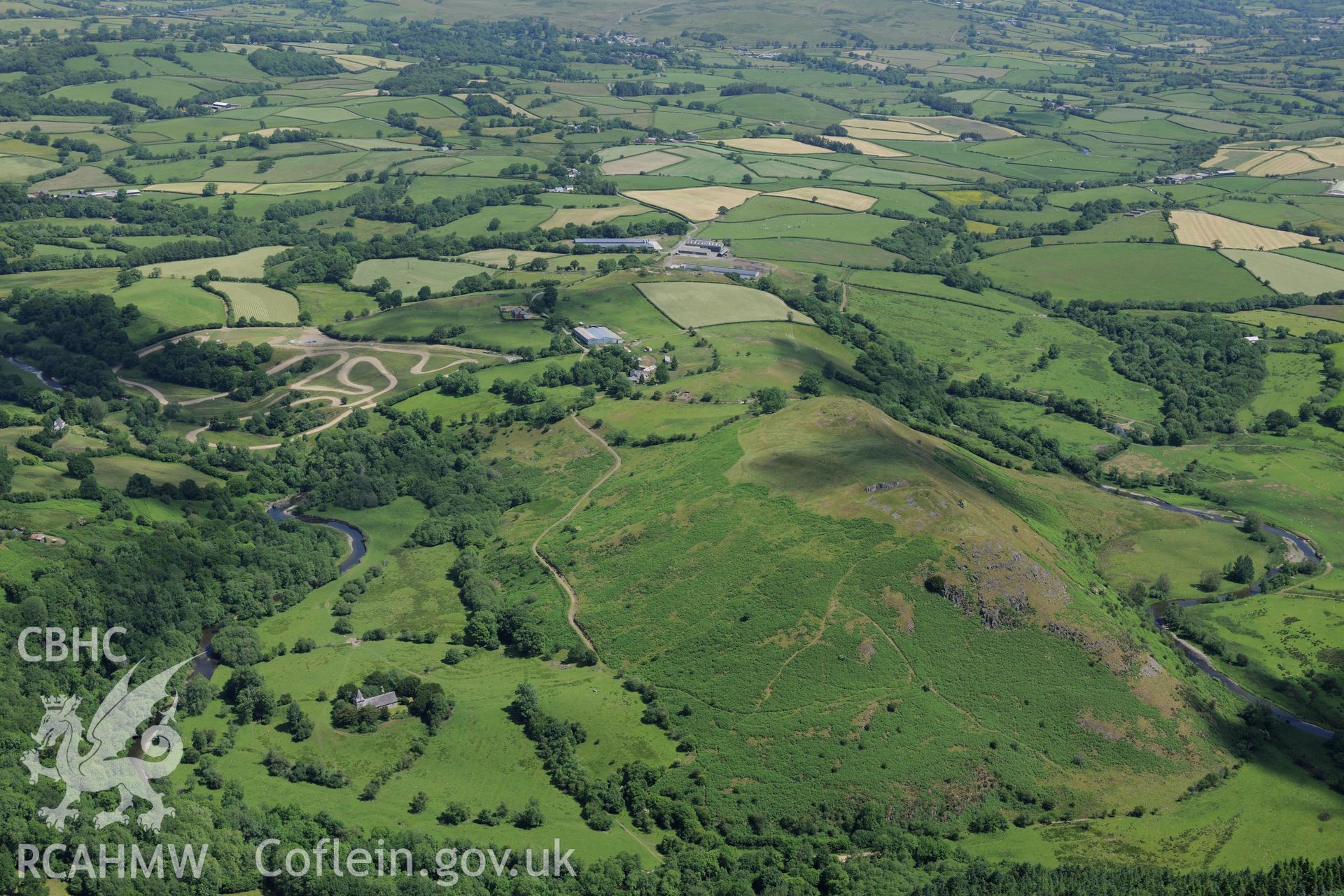 Cefnllys Castle, with St. Mary's church and Neuadd Farm in its shadow, east of Llandrindod Wells. Oblique aerial photograph taken during the Royal Commission's programme of archaeological aerial reconnaissance by Toby Driver on 30th June 2015.