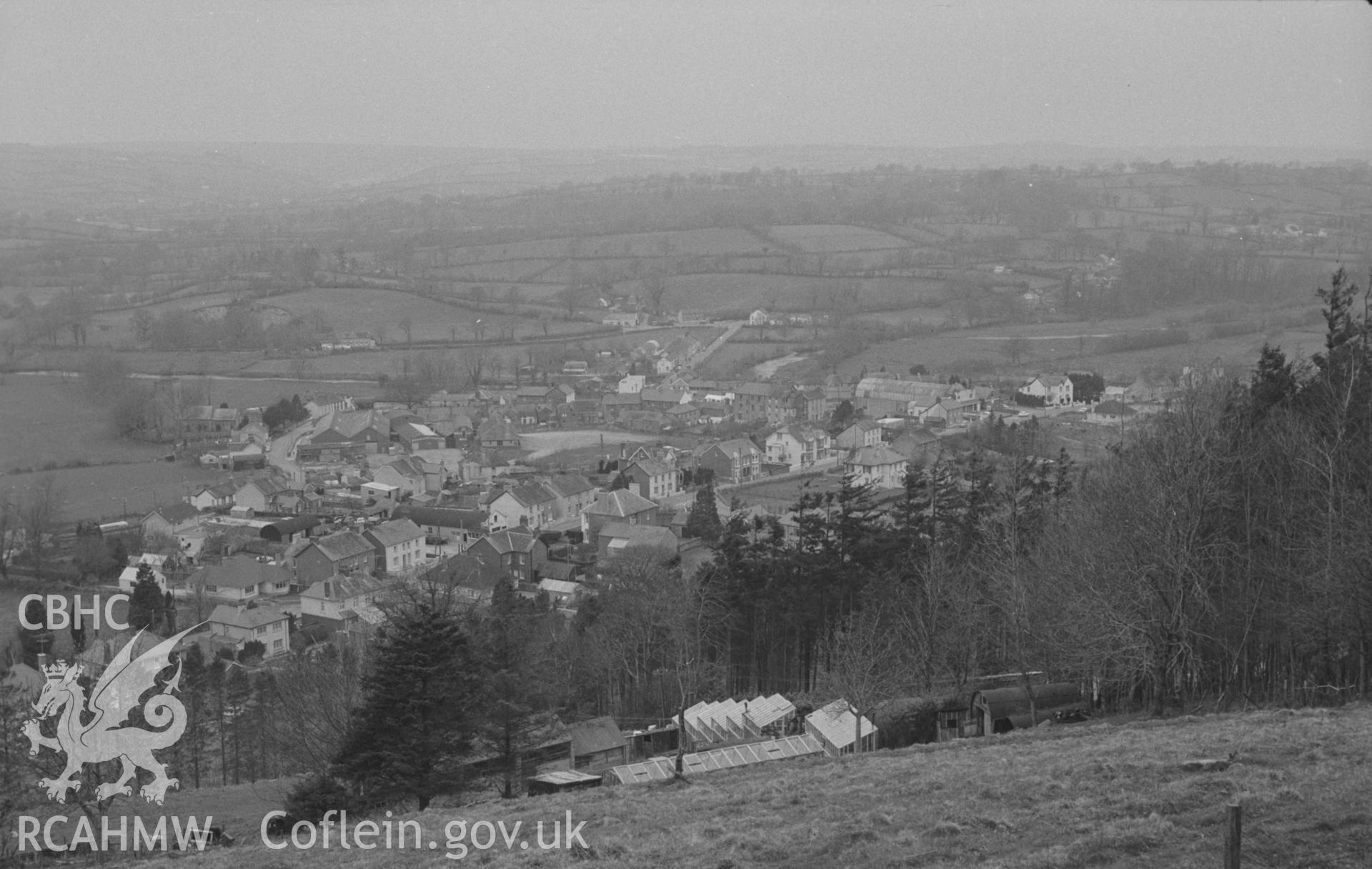 Digital copy of a black and white negative showing view looking from the top of Pen-y-Gaer over Llanybydder; Castell Dol-Wlff across Teifi on right. Photographed by Arthur O. Chater in April 1967 looking north north west from SN 523 434.