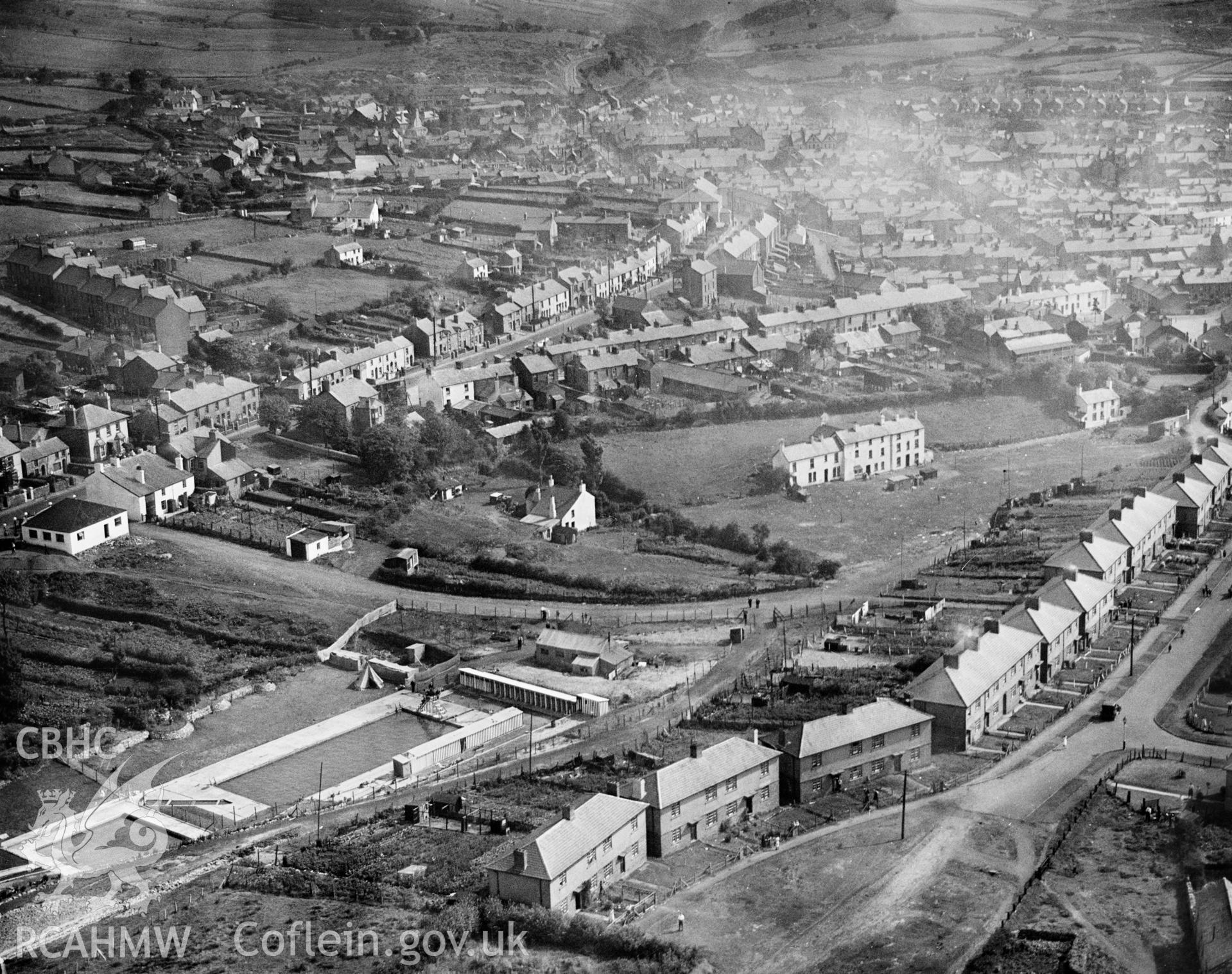 View of Brynmawr showing newly completed swimming pool and council houses, oblique aerial view. 5?x4? black and white glass plate negative.