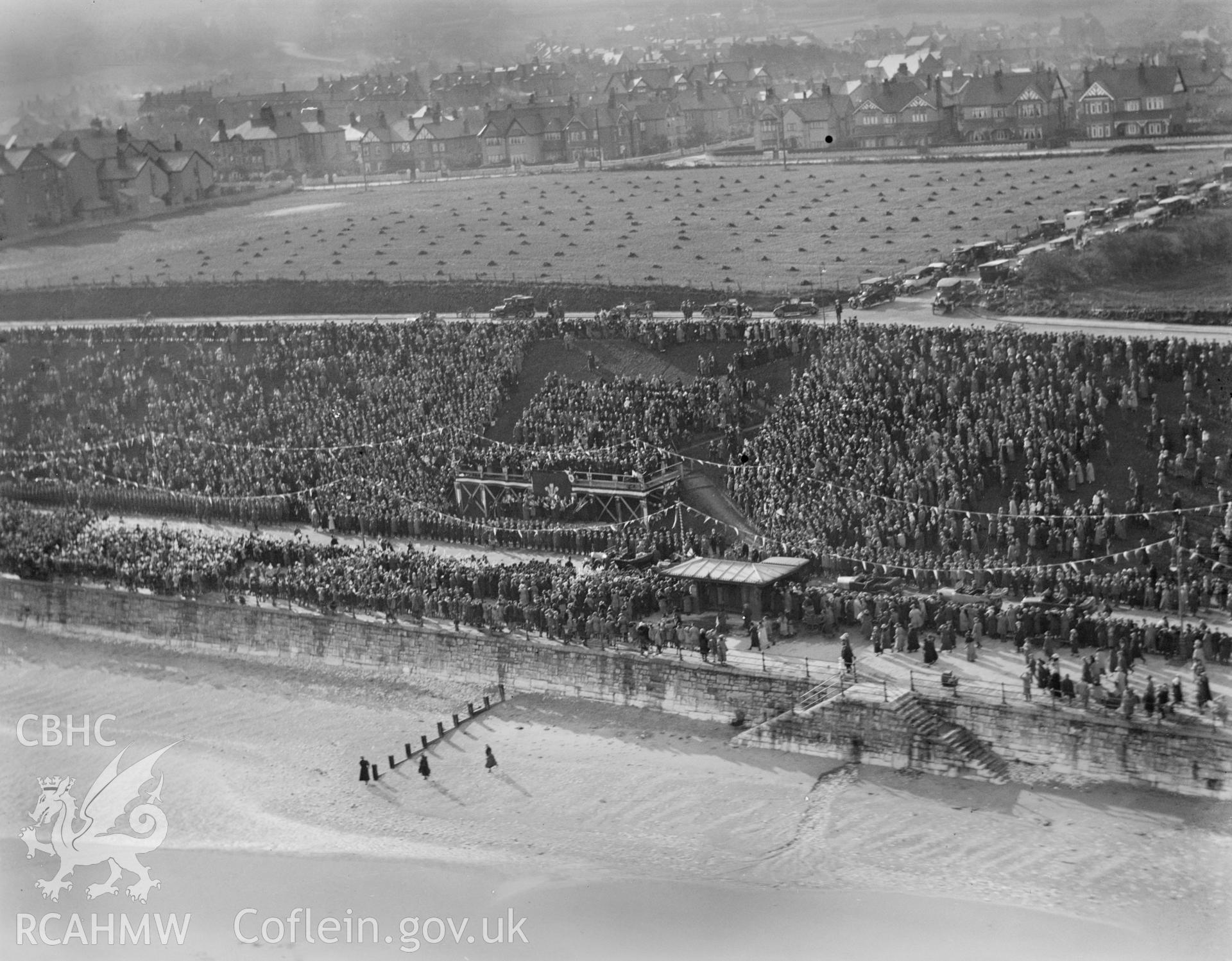 Colwyn Bay showing ceremony and crowds during during the visit of the Prince of Wales (later Edward VIII) in November 1923, oblique aerial view. 5?x4? black and white glass plate negative.