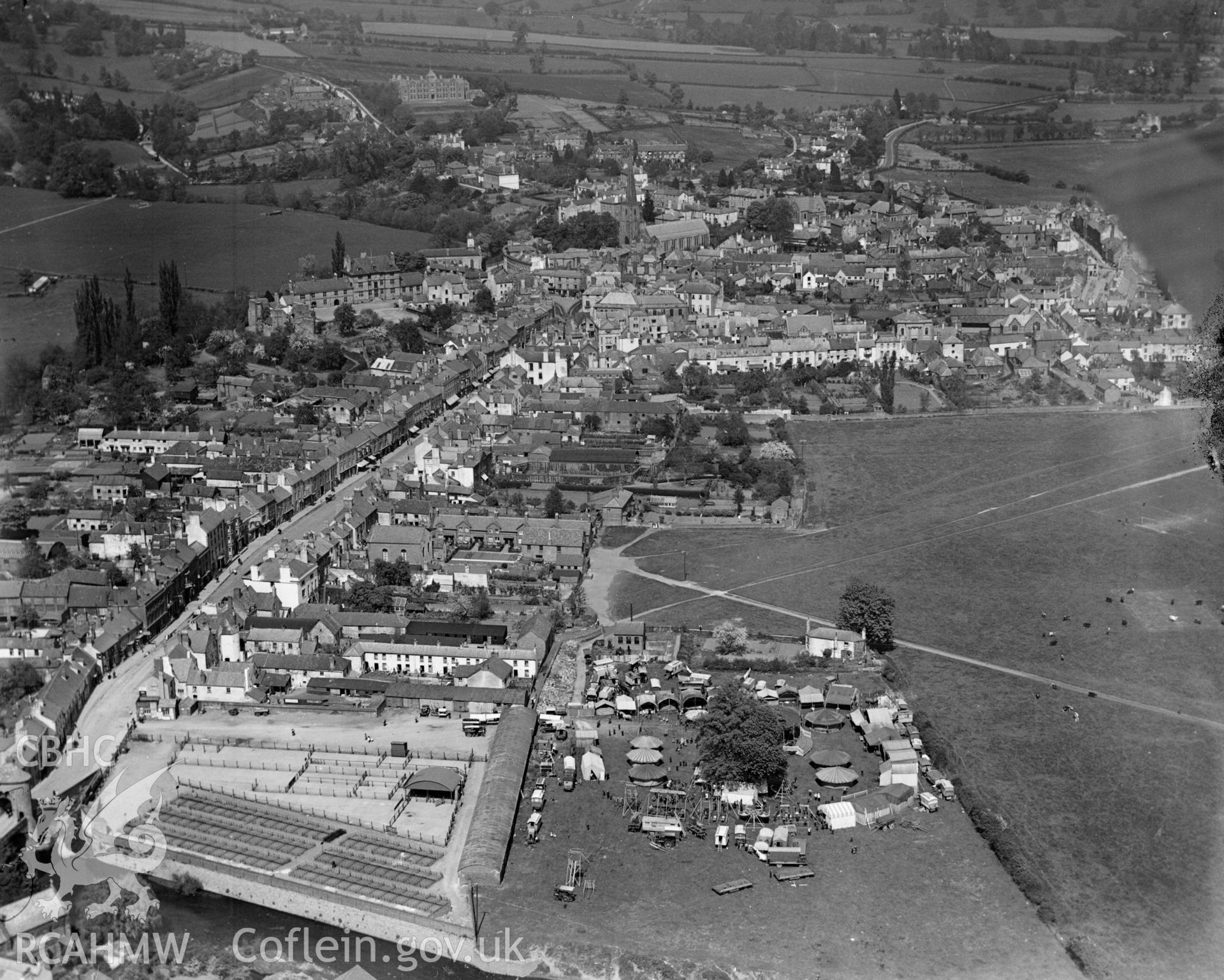 View of Monmouth showing cattle market and fairground with fair in progress, oblique aerial view. 5?x4? black and white glass plate negative.