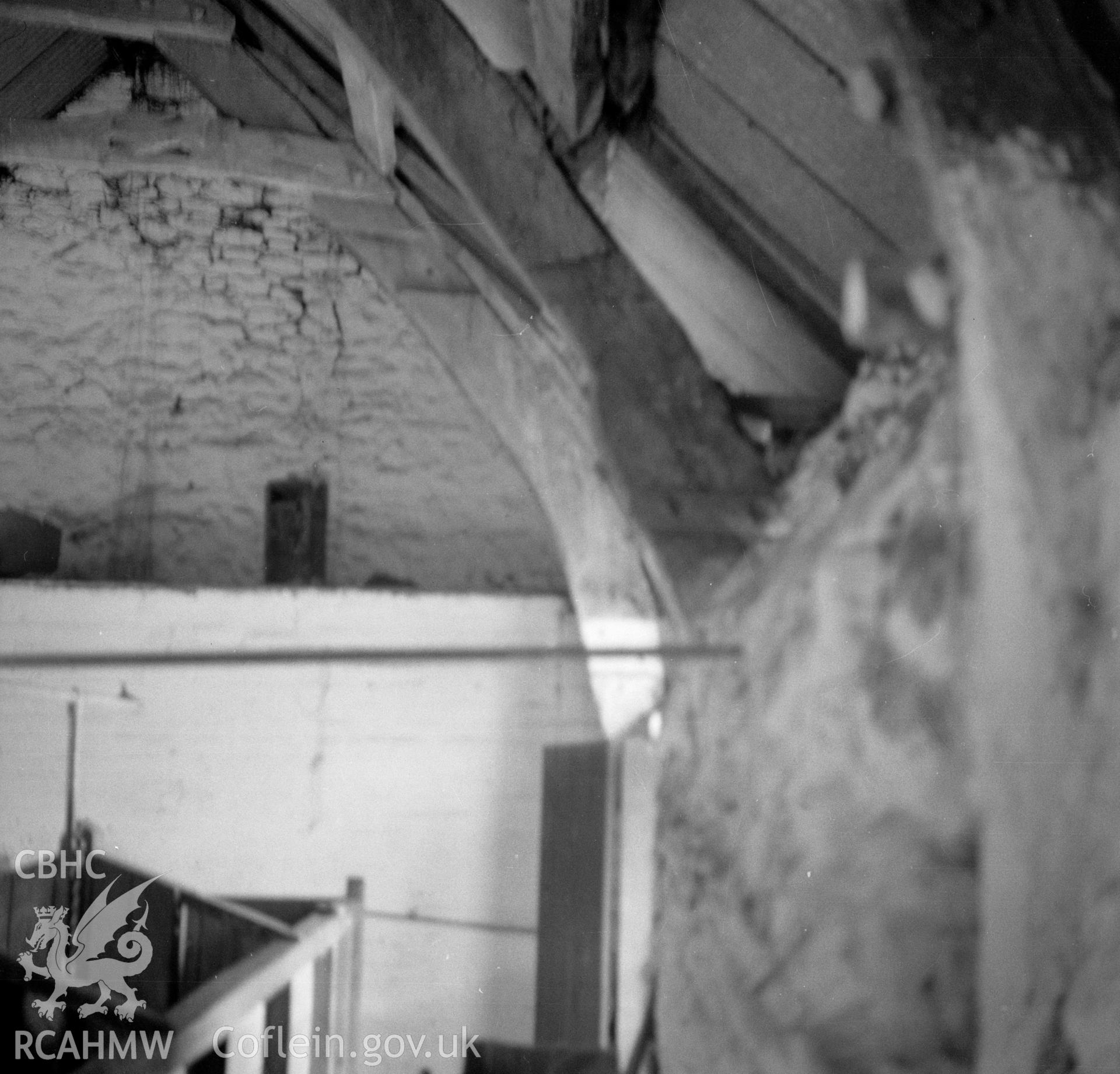 Digital copy of a nitrate negative showing interior view of cruck barn at Maes y Rhiw, Llansadwrn.