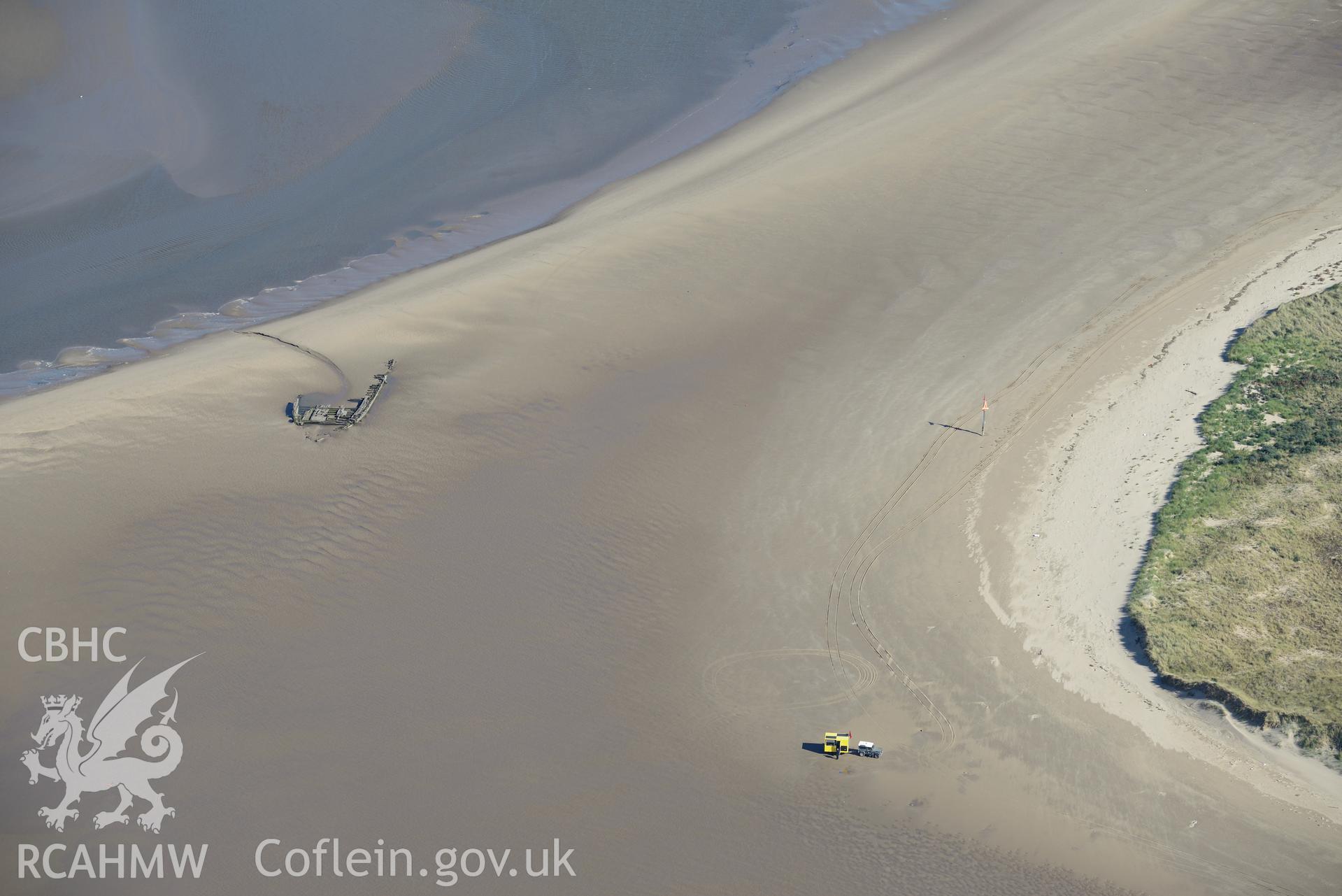 The wreck of 'Paul,' a wooden 4-masted schooner, on Cefn Sidan Sands, west of Kidwelly. Oblique aerial photograph taken during the Royal Commission's programme of archaeological aerial reconnaissance by Toby Driver on 30th September 2015.
