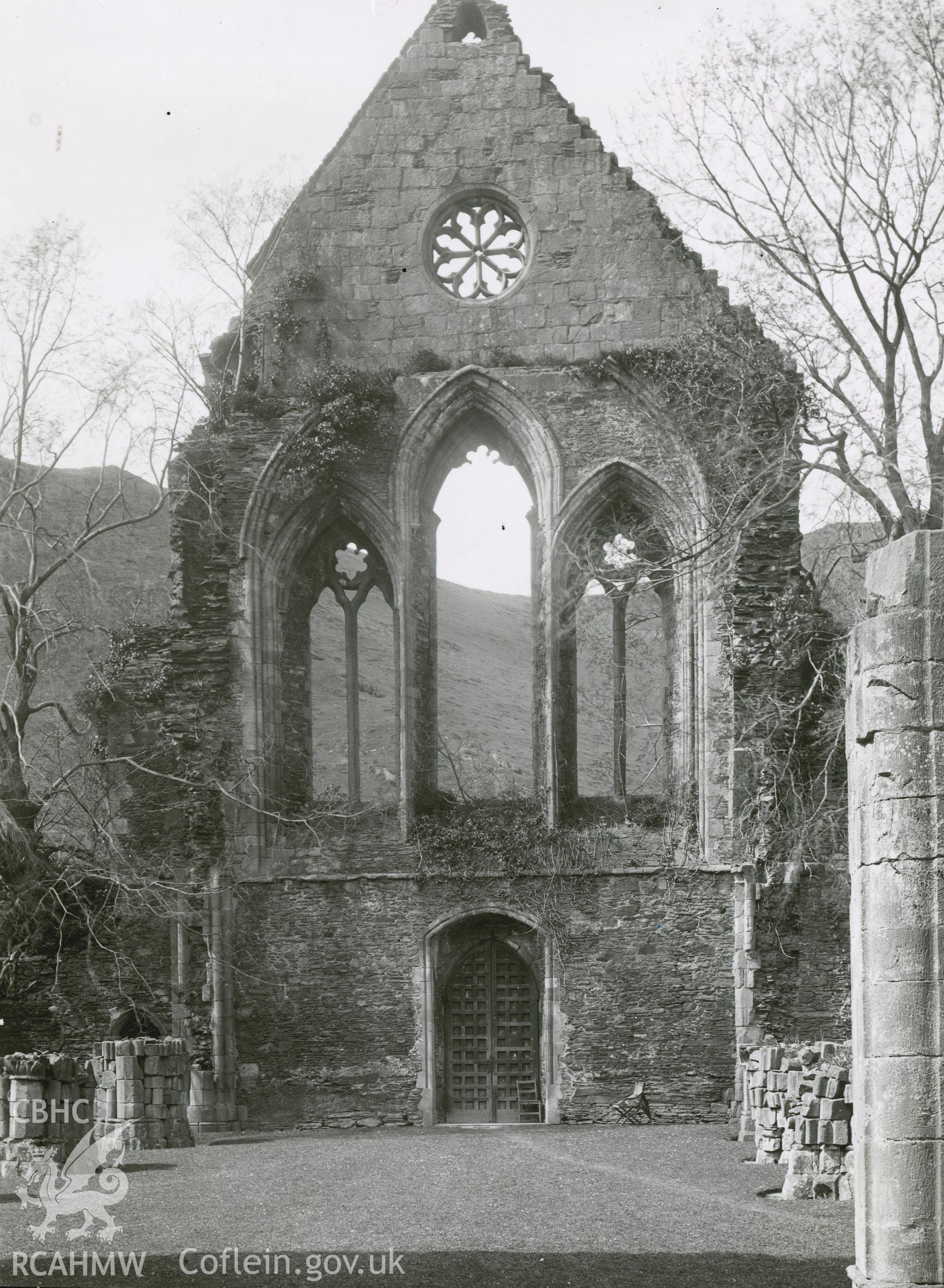 Digitised copy of a black and white photograph showing church interior at Valle Crucis Abbey looking west, taken by F.H. Crossley, 1949. Copied from print as negative held by NMR England (Historic England).