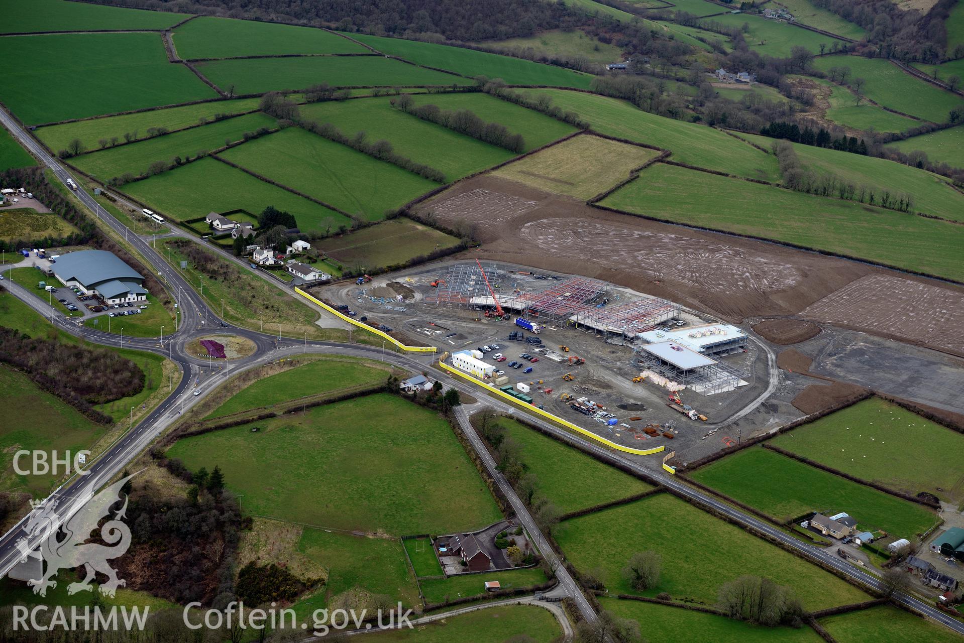 Ysgol Bro Teifi under construction and the A486 Llandysul bypass, on the northern outskirts of Llandysul. Oblique aerial photograph taken during the Royal Commission's programme of archaeological aerial reconnaissance by Toby Driver on 13th March 2015.