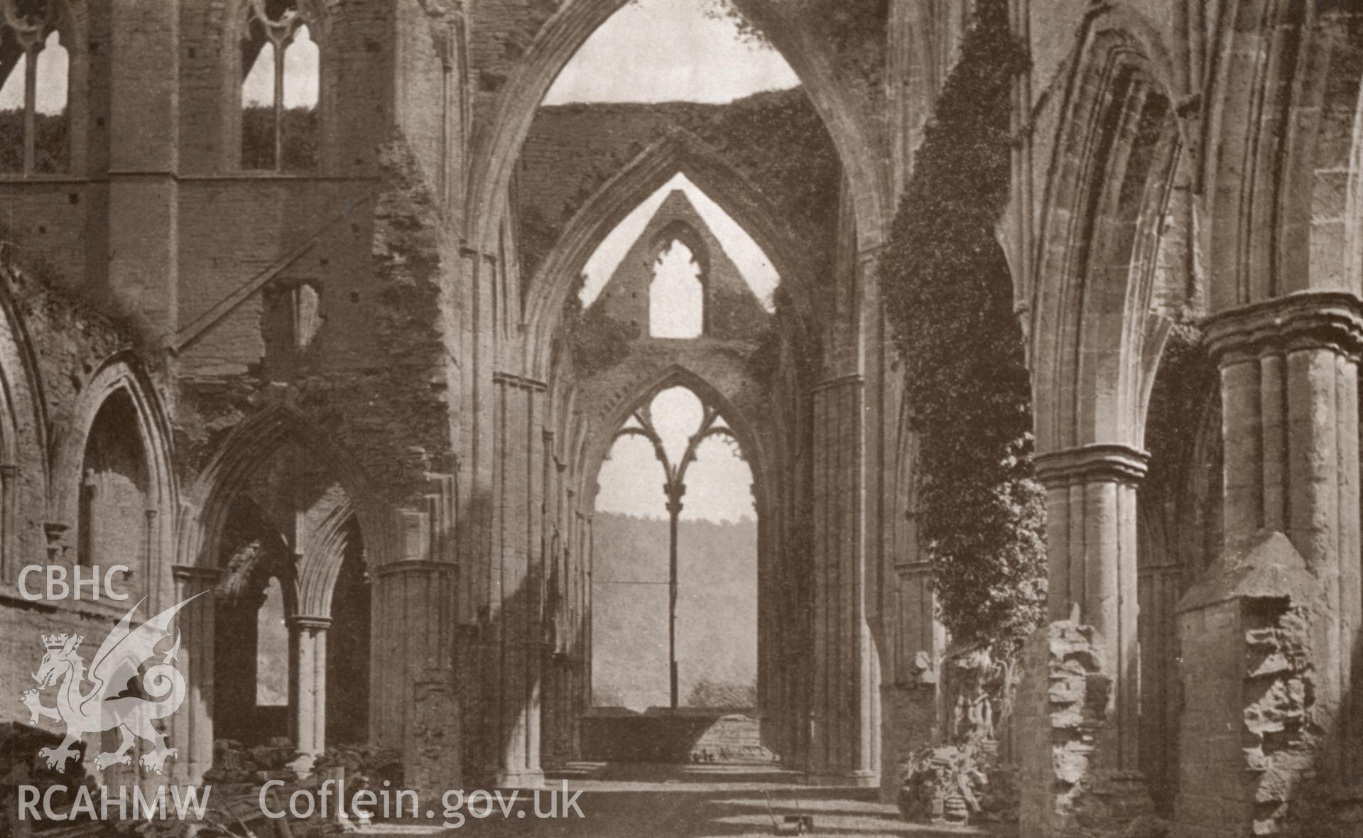 Digital copy of a postcard showing the interior of Tintern Abbey looking east.