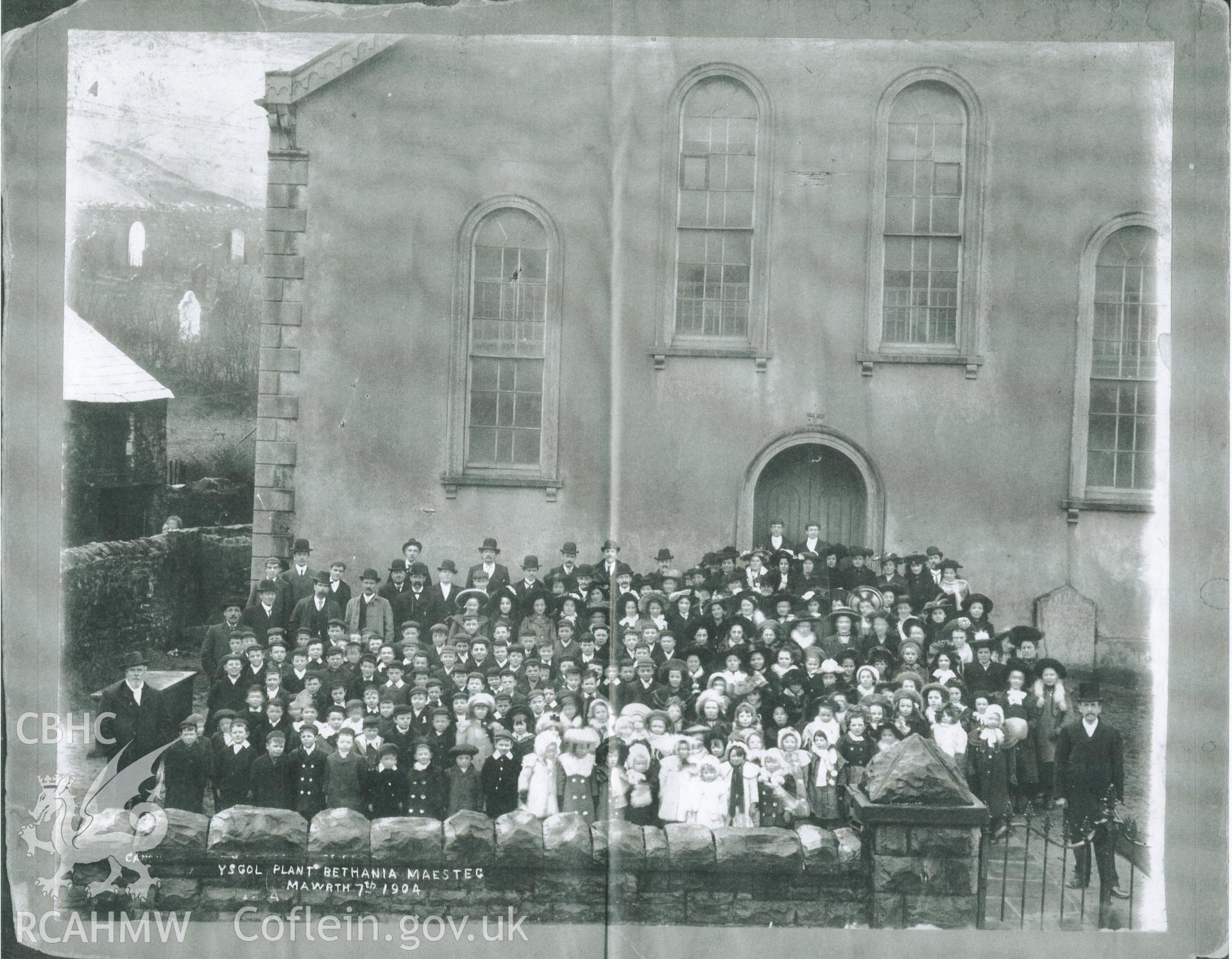 Black and white photograph of members of Ysgol Plant Bethania (Bethania Children's School), Maesteg, taken outside the front of the chapel. Donated to the RCAHMW by Cyril Philips as part of the Digital Dissent Project.