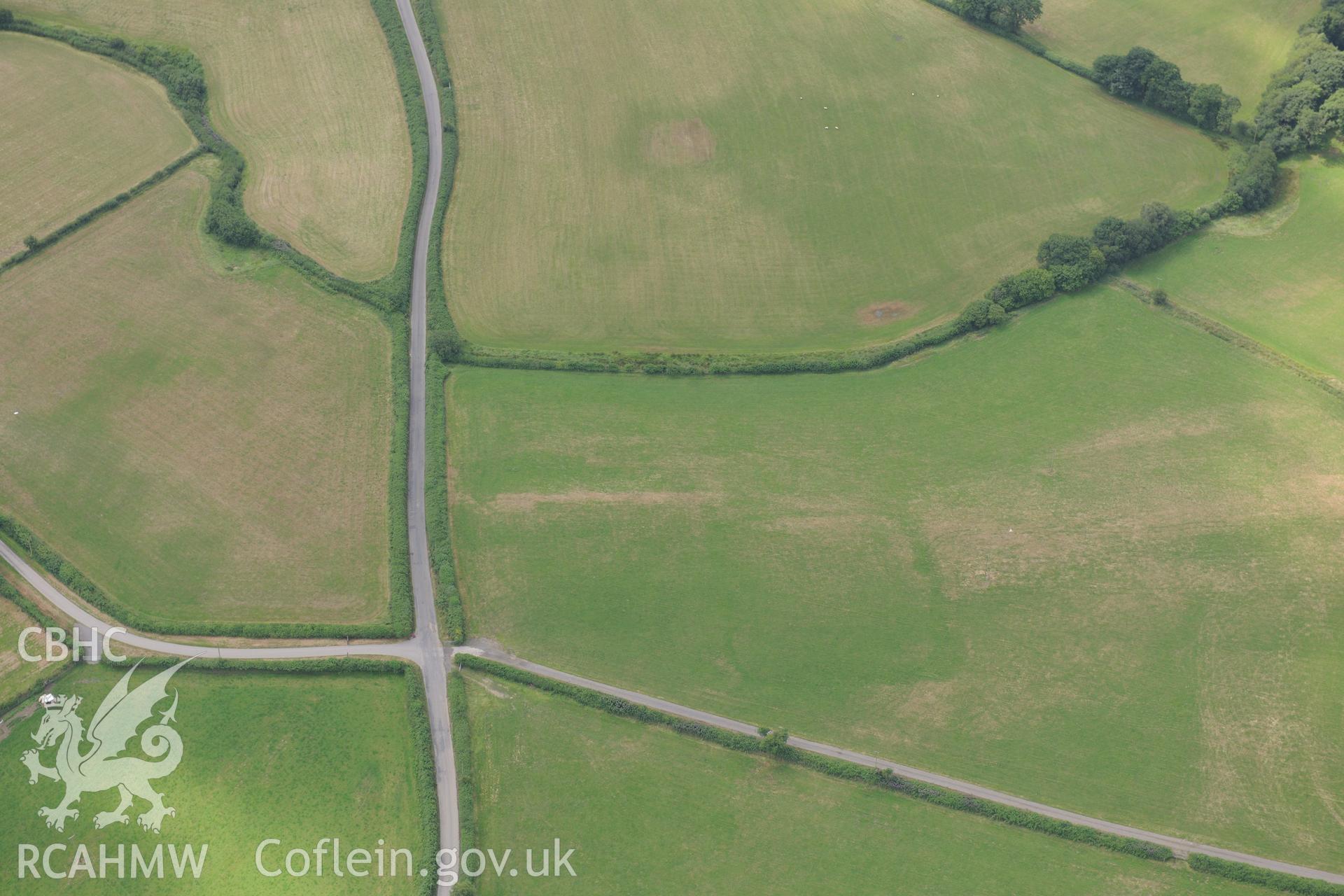 Cropmarks of Roman camp west of Caerau Roman fort, Beulah, west of Builth Wells. Oblique aerial photograph taken during the Royal Commission?s programme of archaeological aerial reconnaissance by Toby Driver on 1st August 2013.