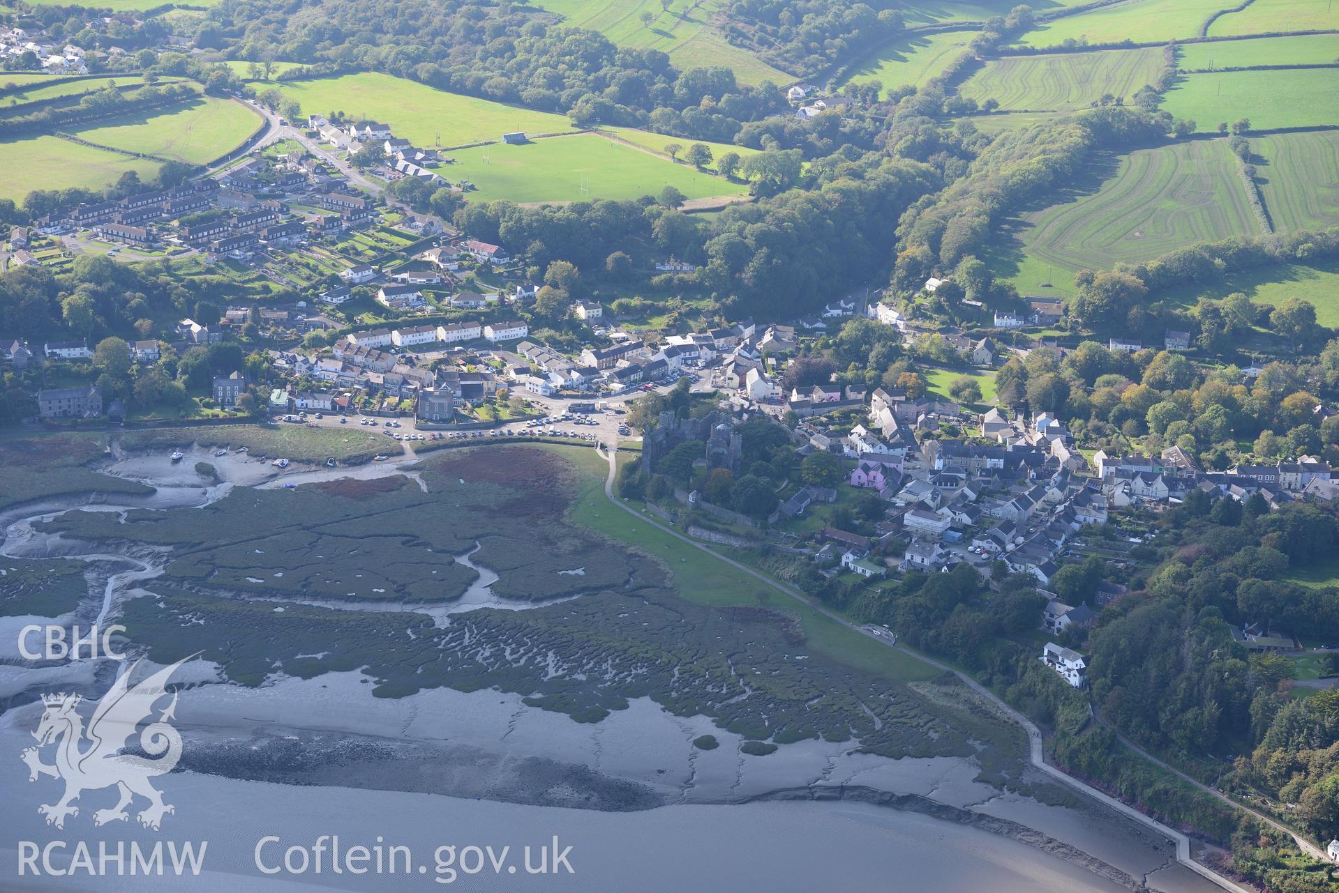 Laugharne Castle and the surrounding town. Oblique aerial photograph taken during Royal Commission's programme of archaeological aerial reconnaissance by Toby Driver on 30th September 2015.