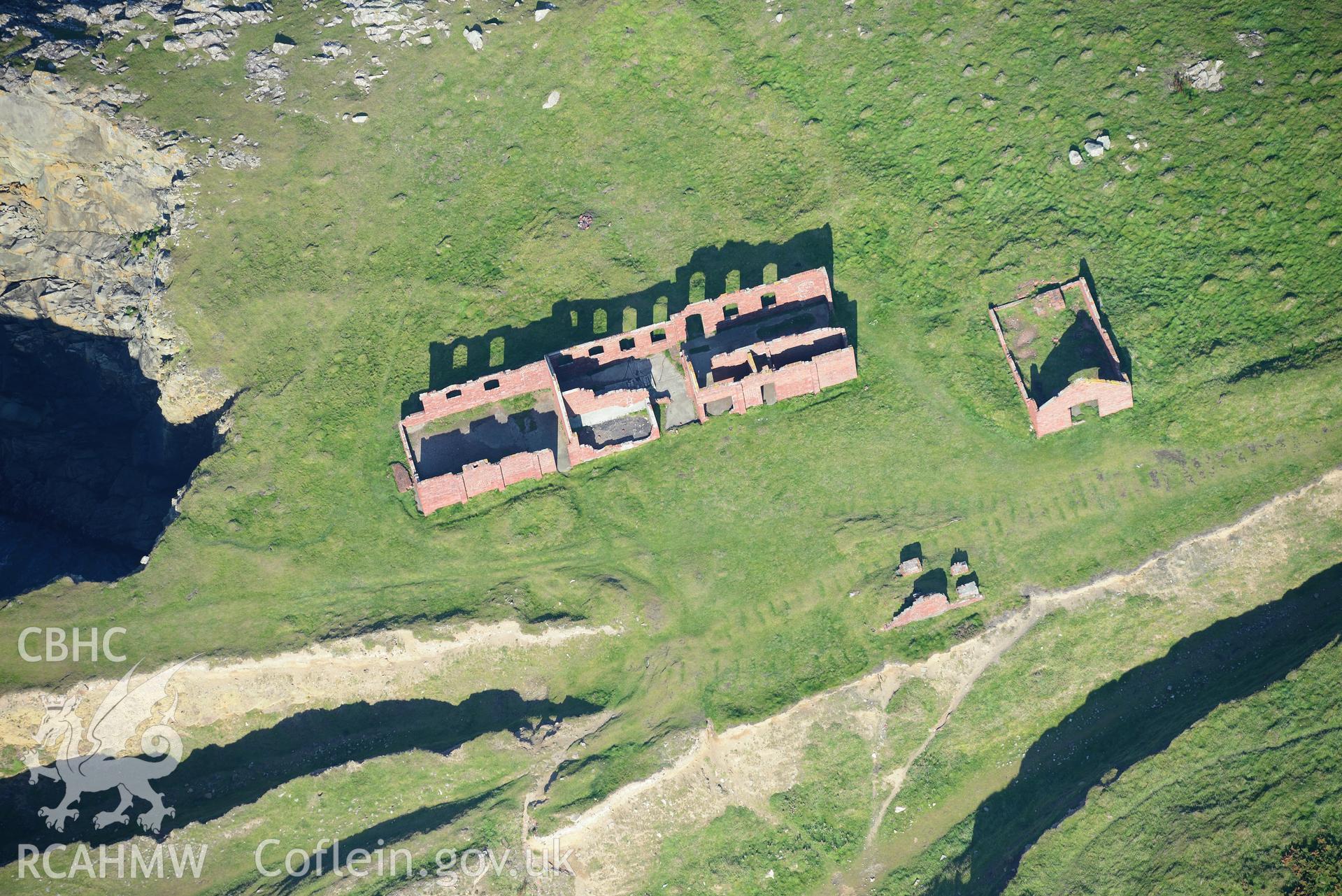 Remains of Porthgain stone quarry, including the offices and stores. Oblique aerial photograph taken during the Royal Commission's programme of archaeological aerial reconnaissance by Toby Driver on 30th September 2015.